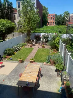a view of a backyard with sitting area