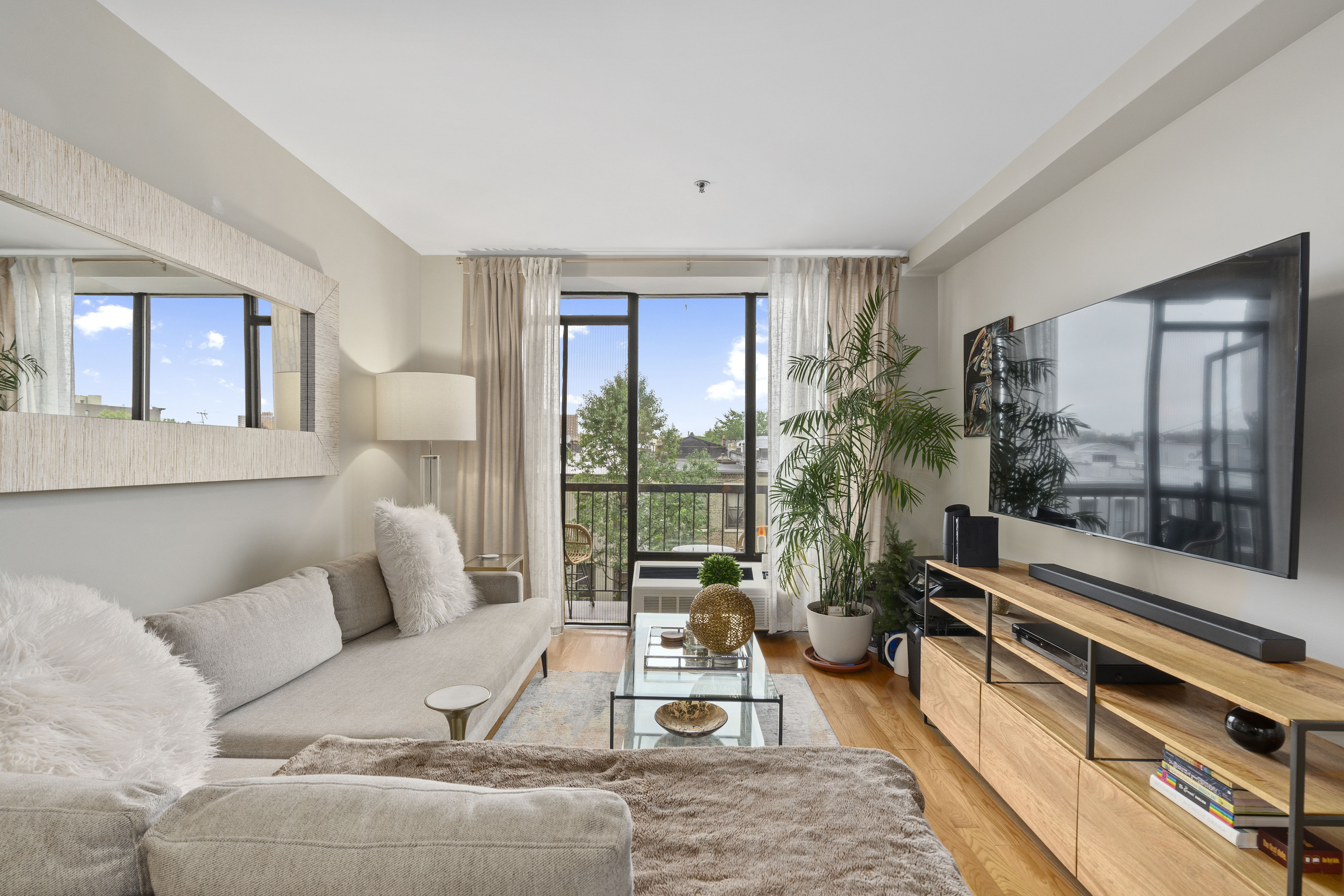 239 West 135th Street, Unit 5B Manhattan, NY 10030 - Photo 4 of 6 a living room with furniture and a large window