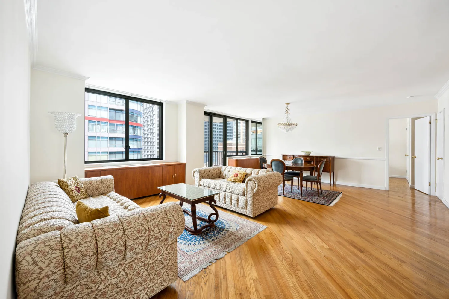 a living room with furniture and a wooden floor