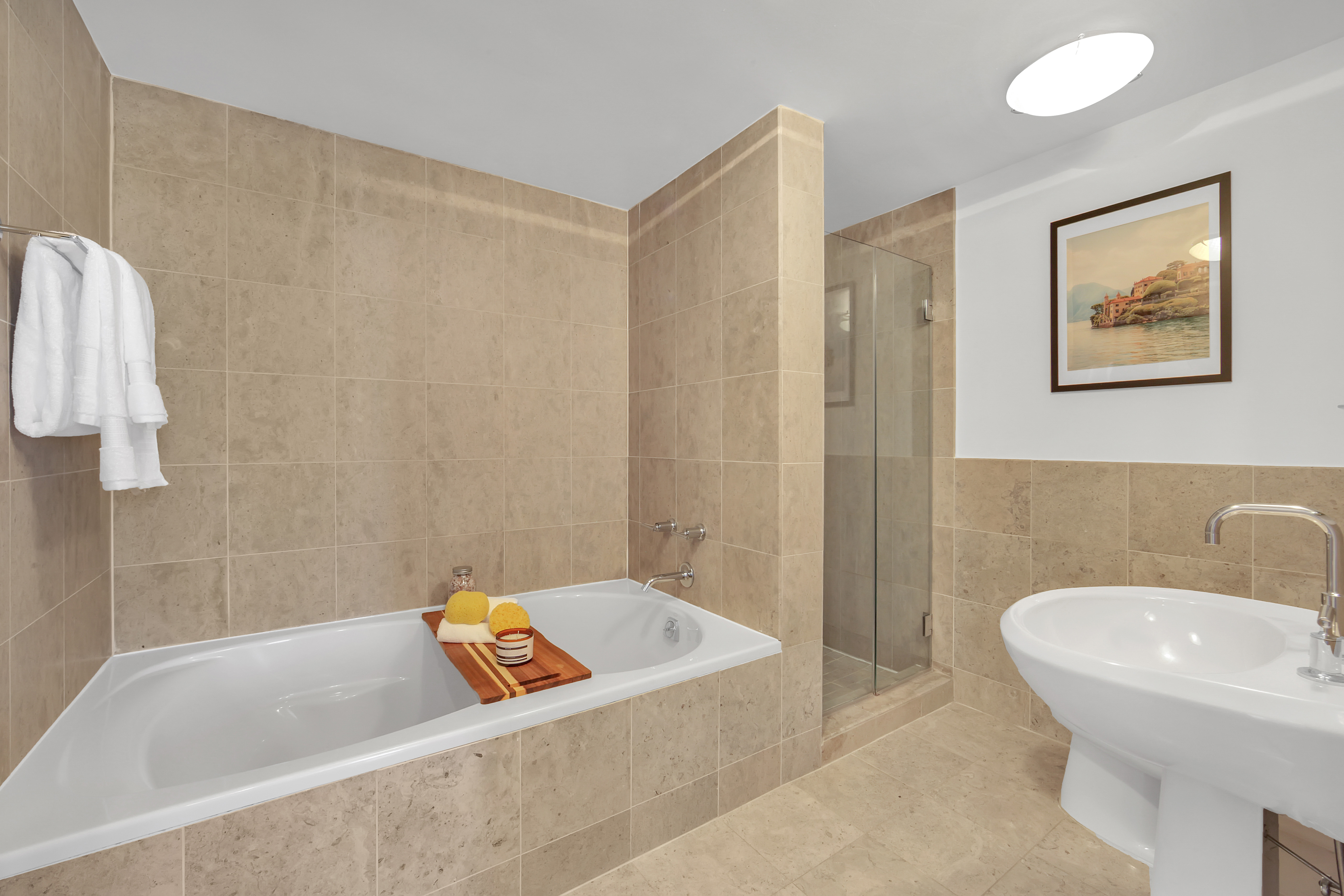 1485 5th Avenue, Unit 18/19H Manhattan, NY 10035 - Photo 13 of 24 a bathroom with a bathtub and a sink