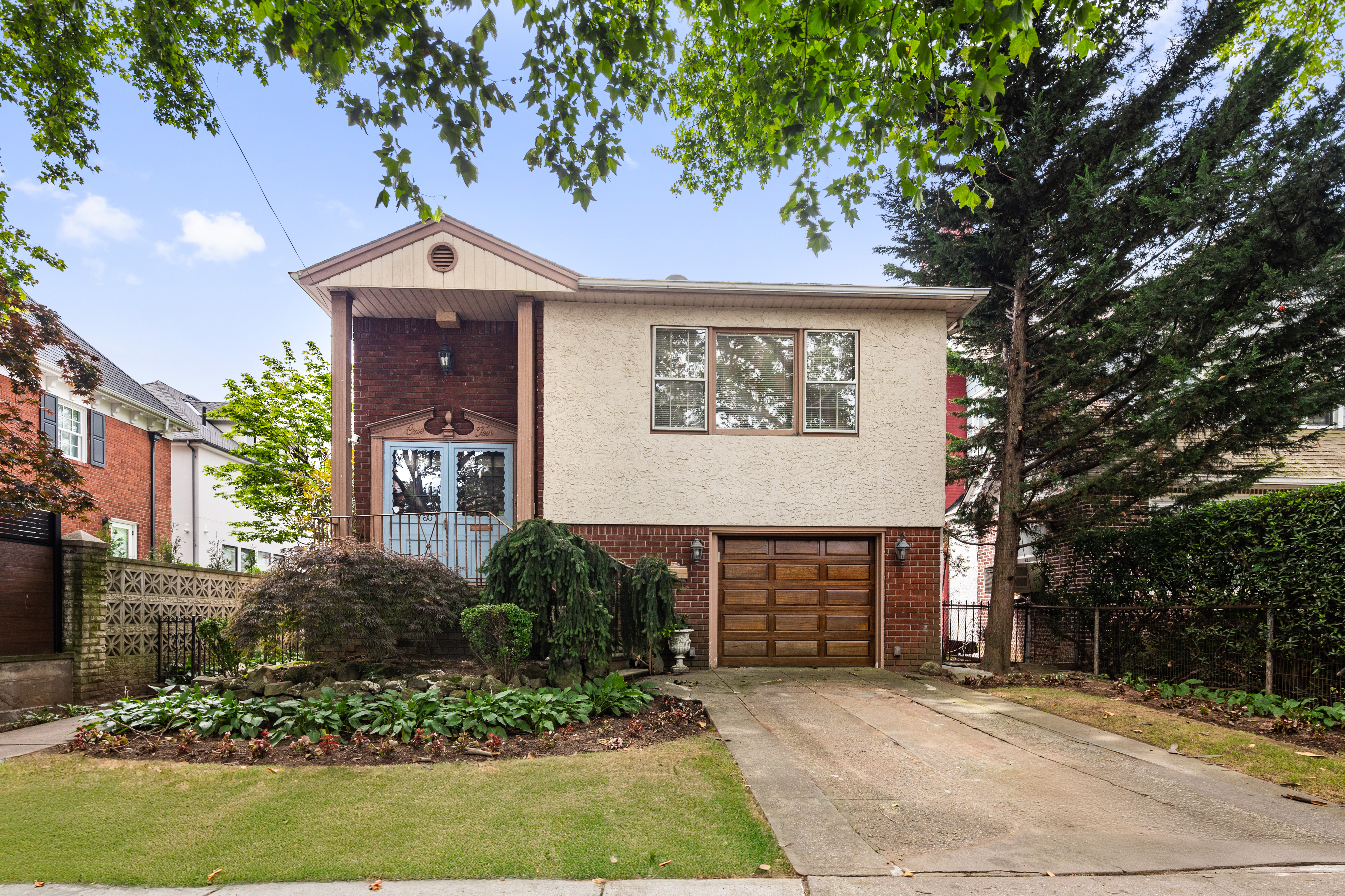 a front view of a house with garden