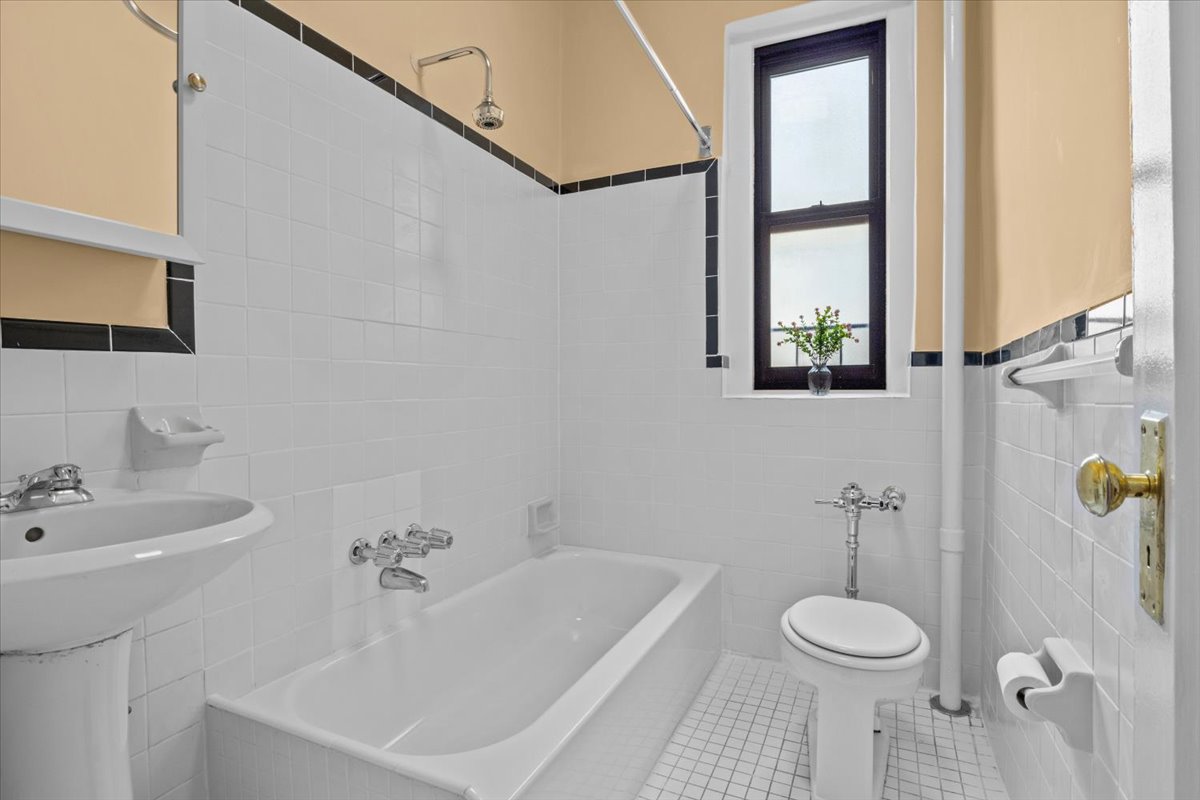 7101 Colonial Road, Unit R3E Brooklyn, NY 11209 - Photo 11 of 19 a bathroom with a sink a toilet and shower