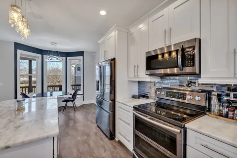 a kitchen with a stove a sink and a microwave