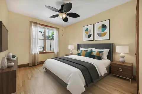 a bedroom with a bed and a large window