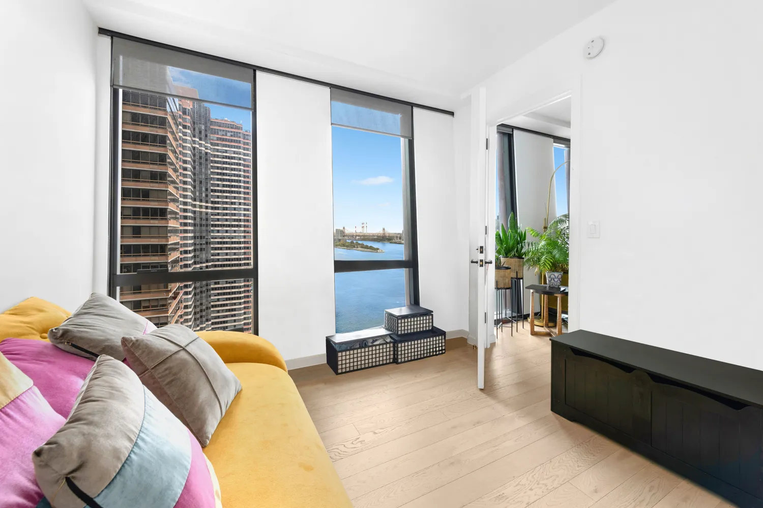 a bedroom with a bed and a potted plant