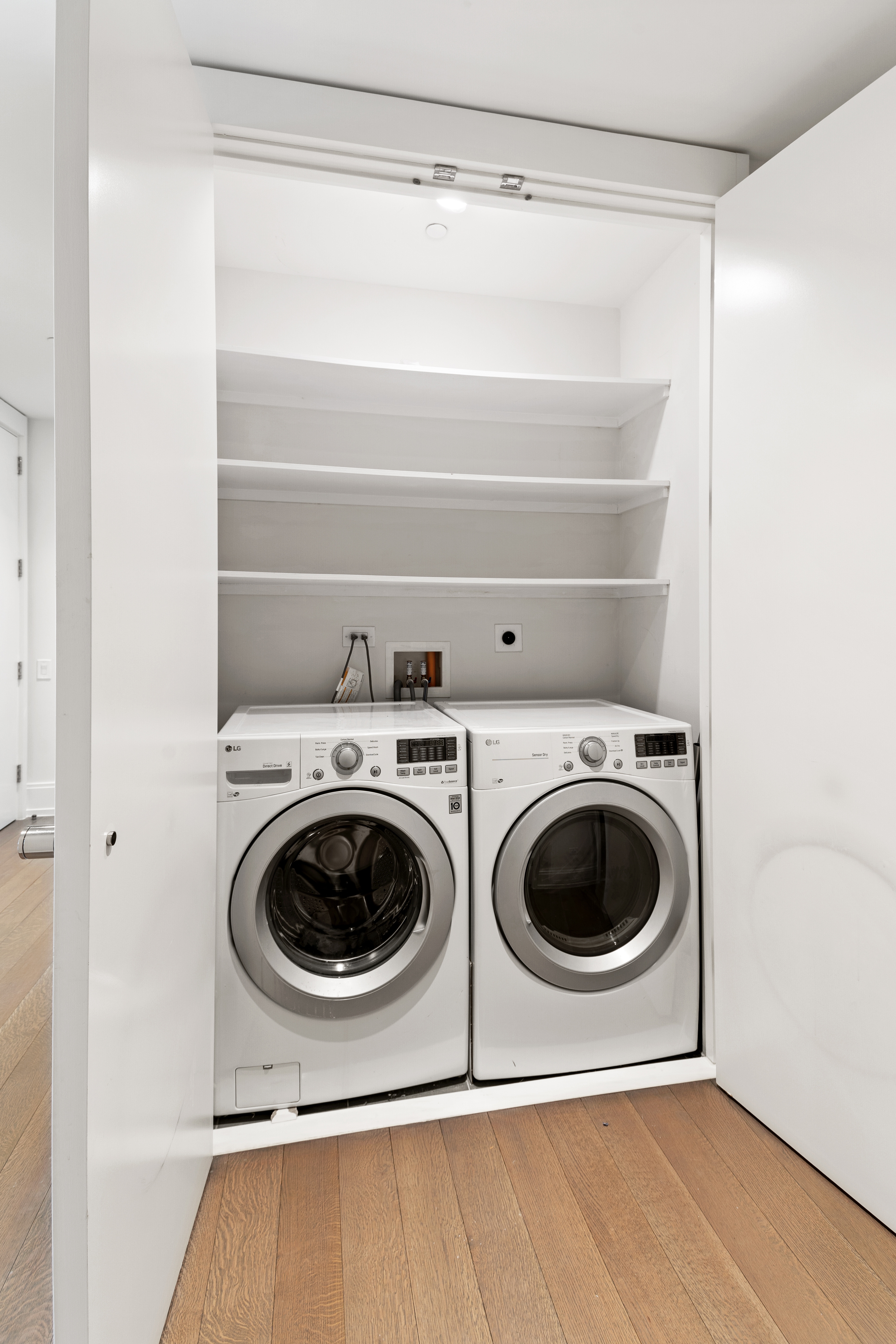 301 East 50th Street, Unit 17B Manhattan, NY 10022 - Photo 4 of 12 a utility room with dryer and washer