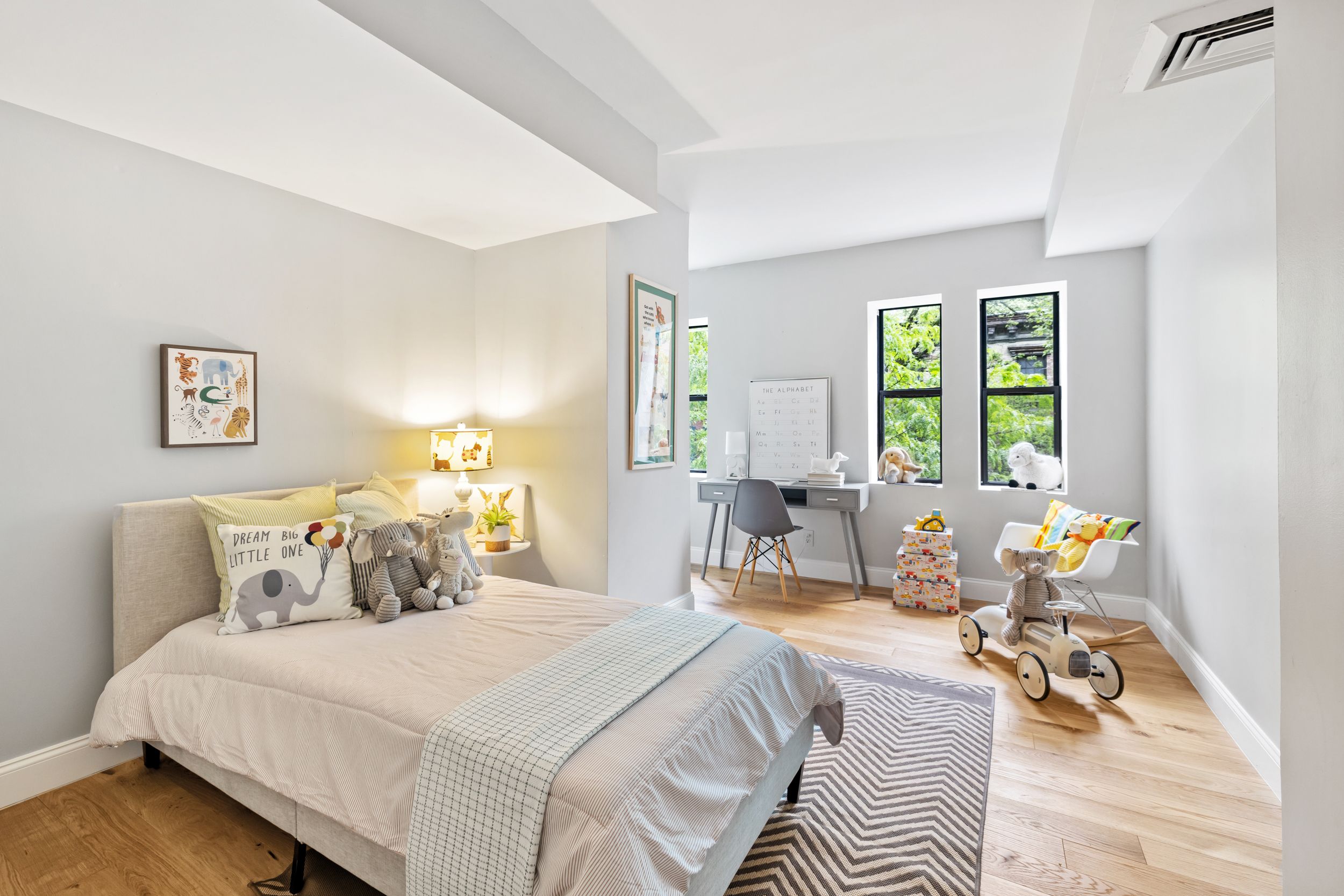 248 East 31st Street, Unit 4A Manhattan, NY 10016 - Photo 9 of 14 a bedroom with a bed and wooden floor