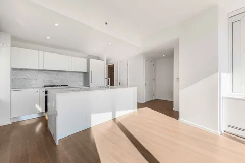 a kitchen with a refrigerator and a sink