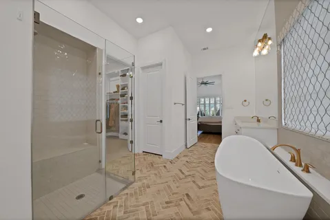 a spacious bathroom with a bathtub and shower