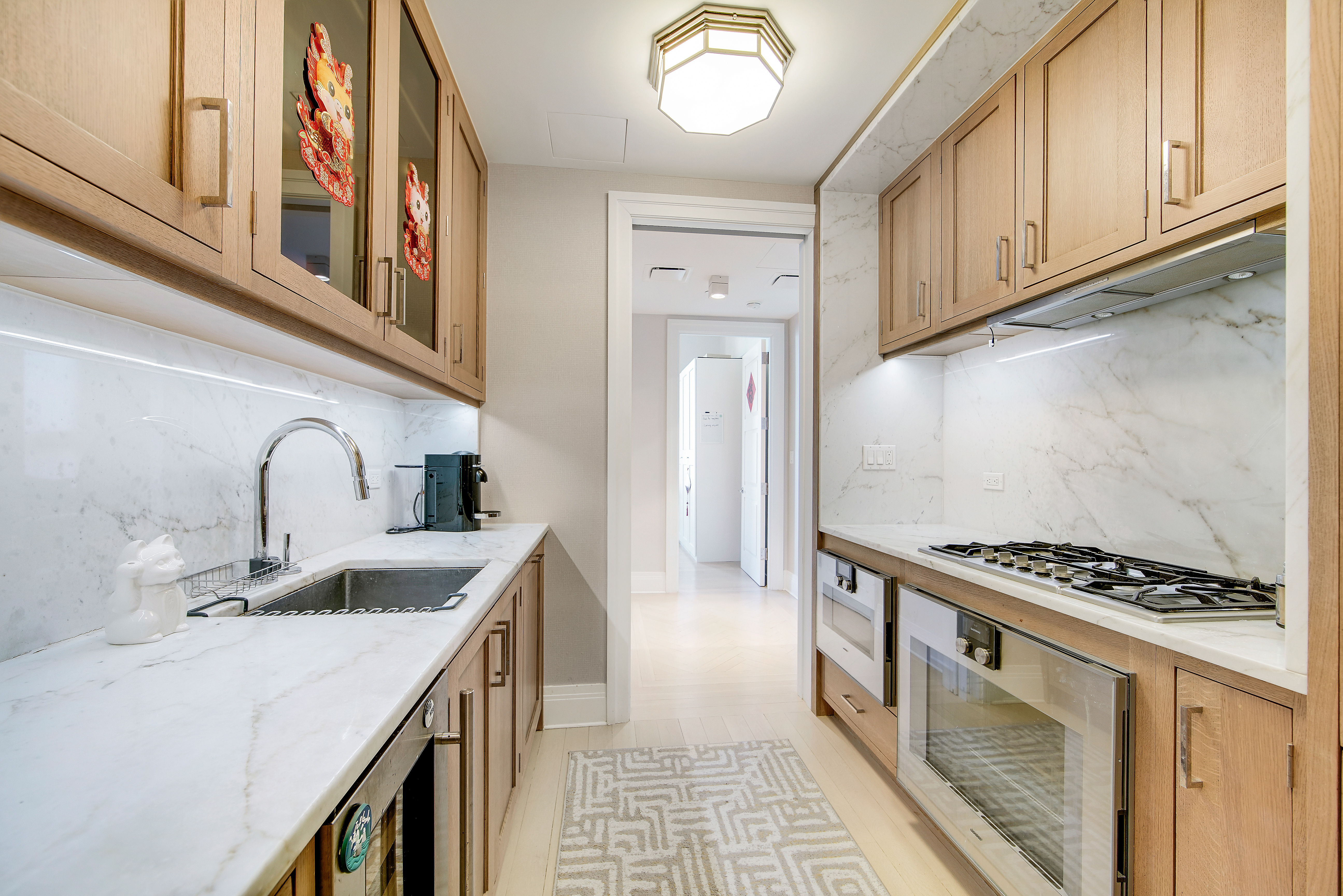 30 Park Place, Unit 46C Manhattan, NY 10007 - Photo 9 of 20 a kitchen with stainless steel appliances granite countertop a sink and cabinets