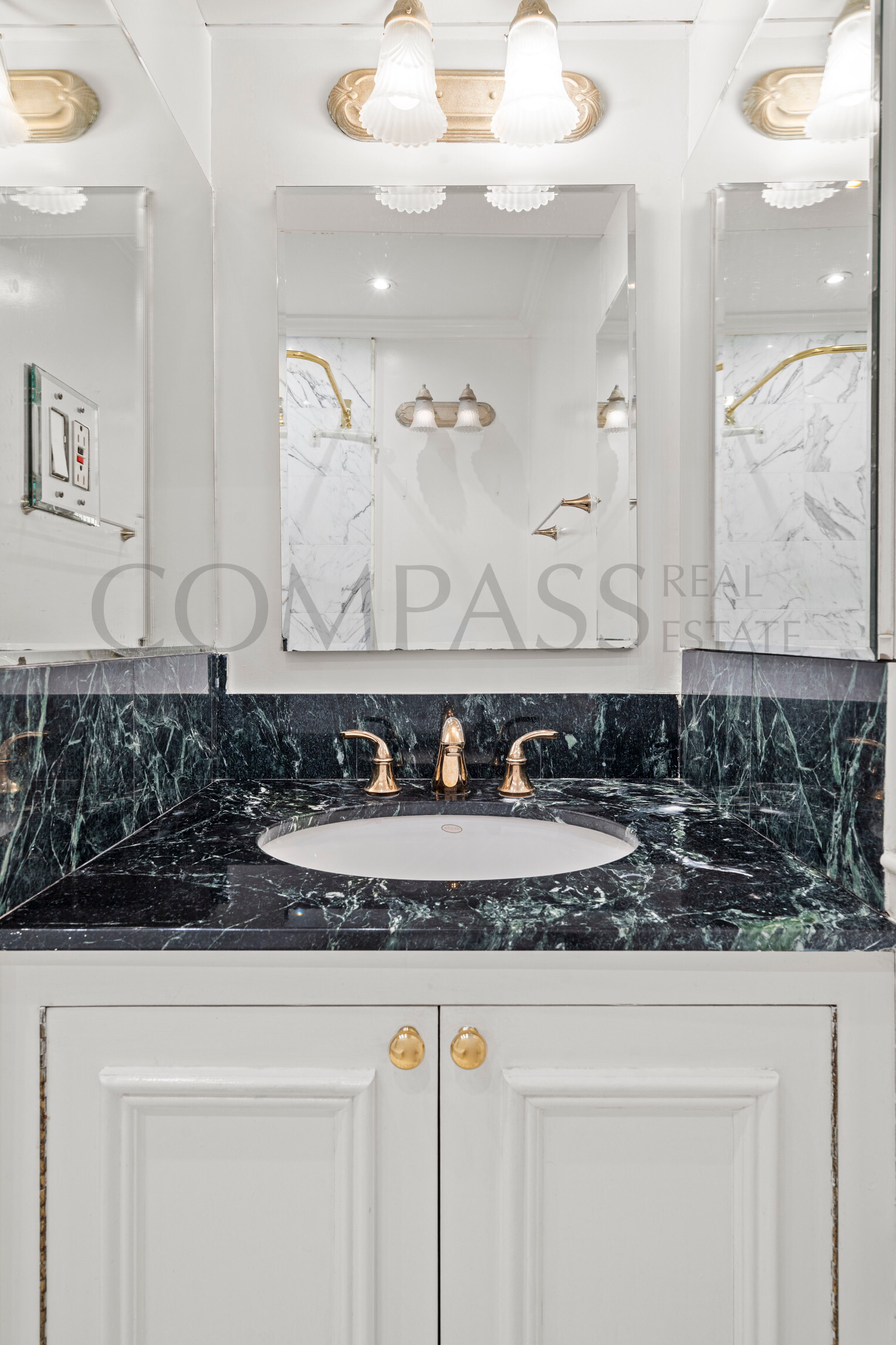 45 East 89th Street, Unit Undisclosed Manhattan, NY 10128 - Photo 7 of 10 a bathroom with a sink and a mirror