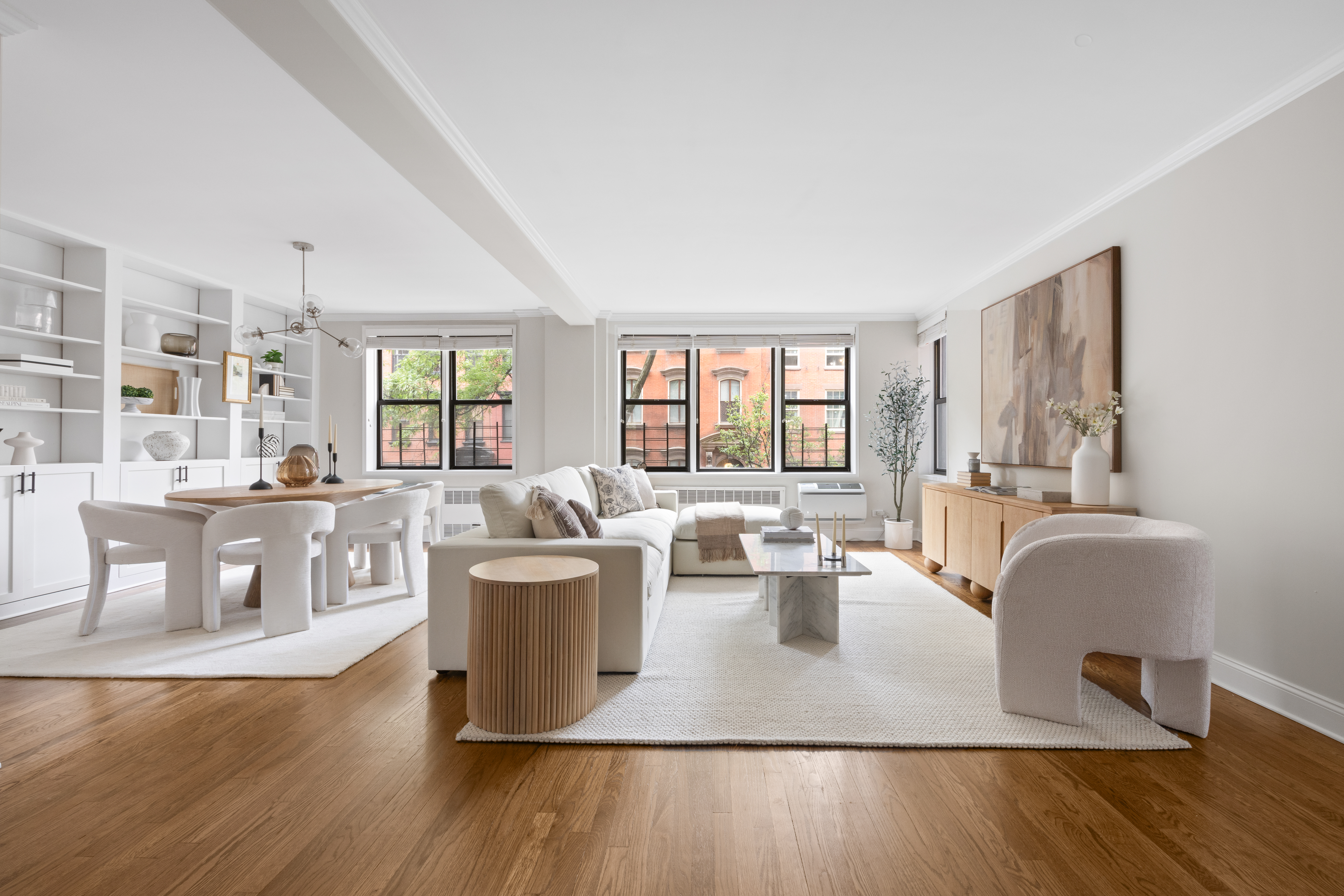 211 East 18th Street, Unit 2O Manhattan, NY 10003 - Photo 12 of 14 a living room with furniture a large window and wooden floor