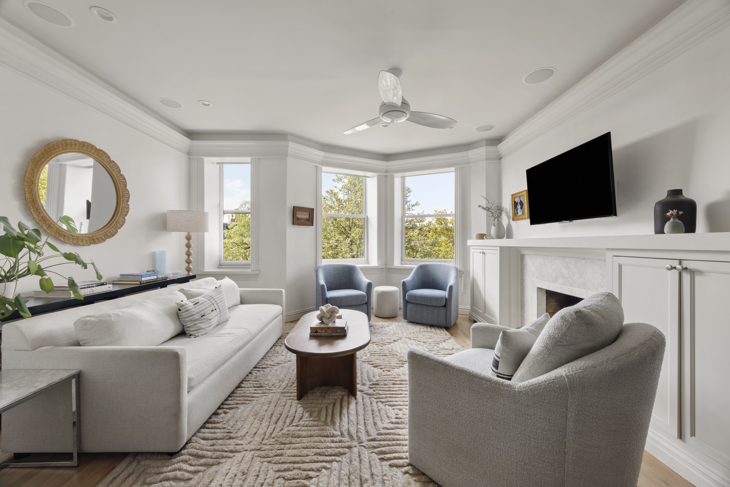a living room with furniture a fireplace and a flat screen tv