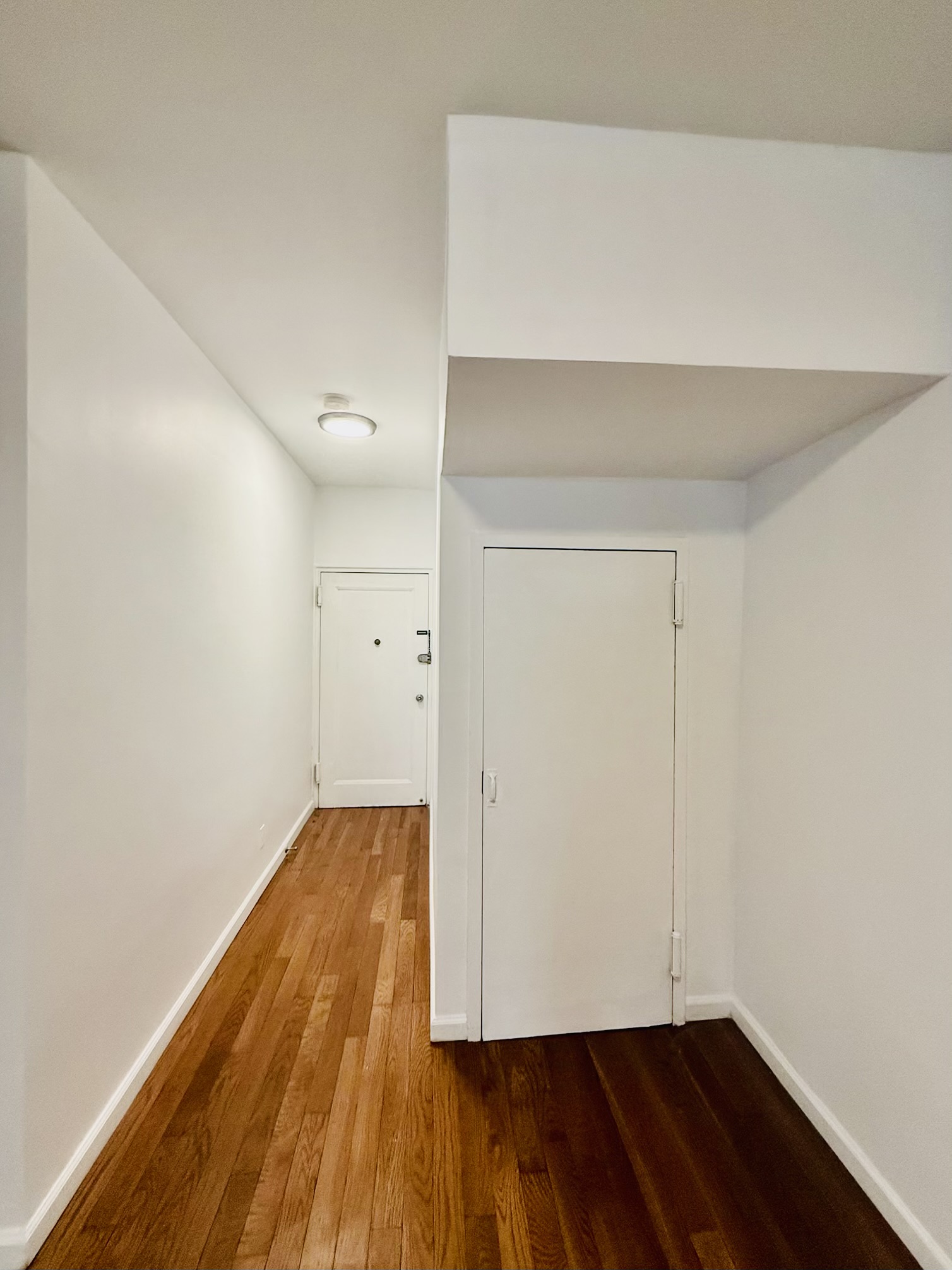 18-48 21st Drive, Unit 1R Queens, NY 11105 - Photo 10 of 11 a view of wooden floor
