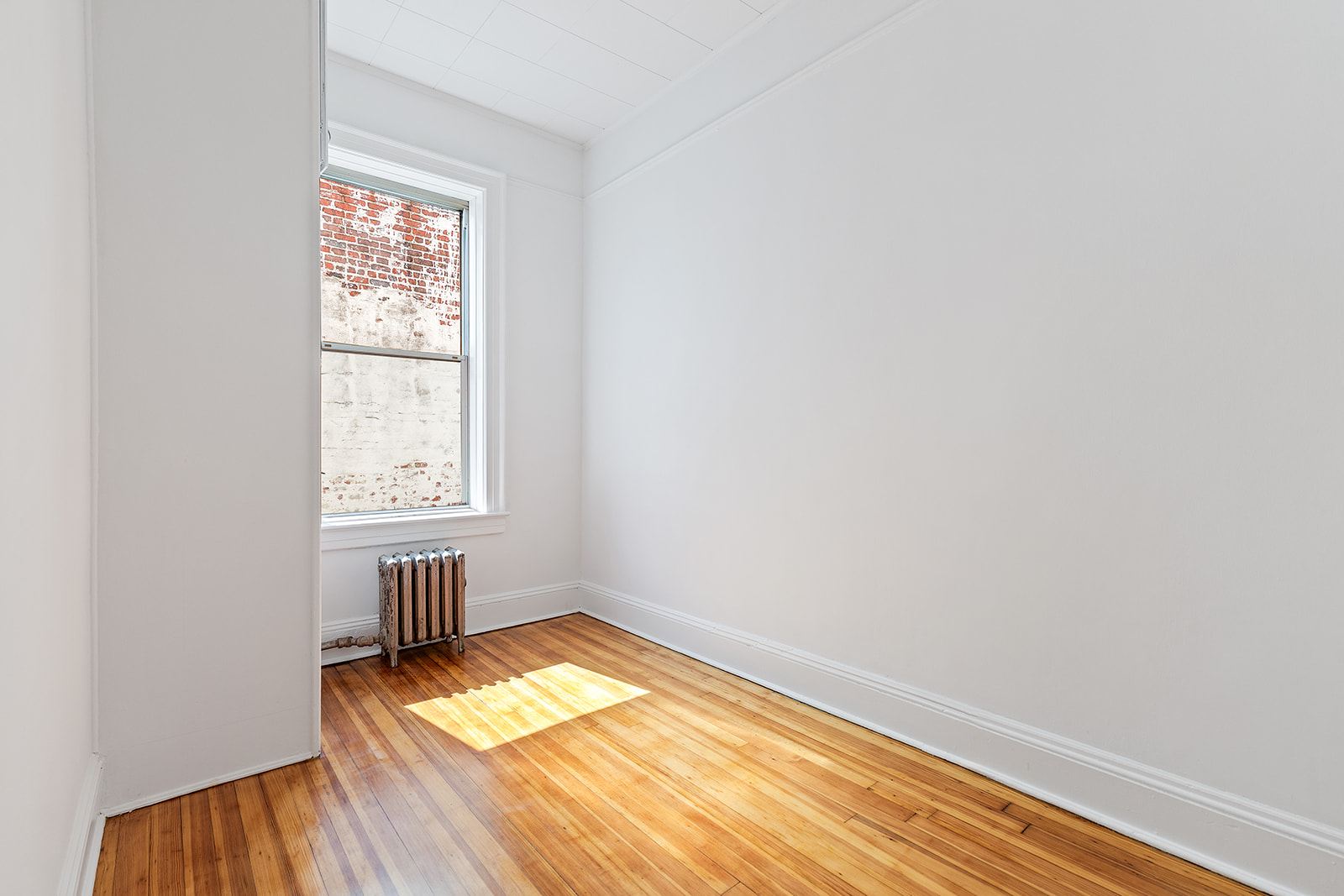 4401 4th Avenue, Unit D4 Brooklyn, NY 11220 - Photo 6 of 7 an empty room with a window