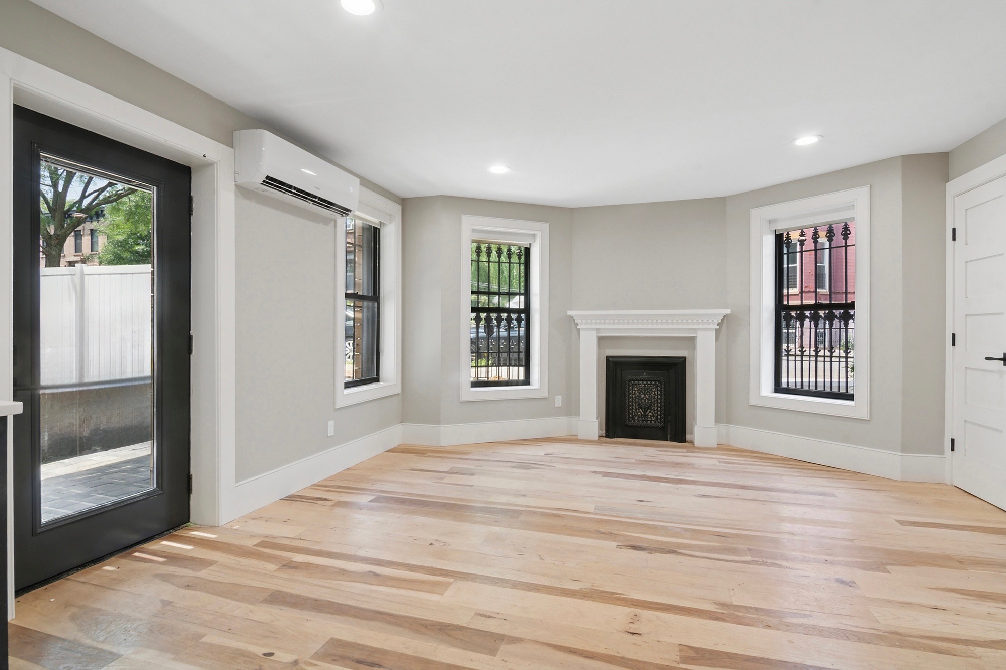 264 Stuyvesant Avenue, Unit 1 Brooklyn, NY 11221 - Photo 3 of 9 a view of an empty room with window and fire place