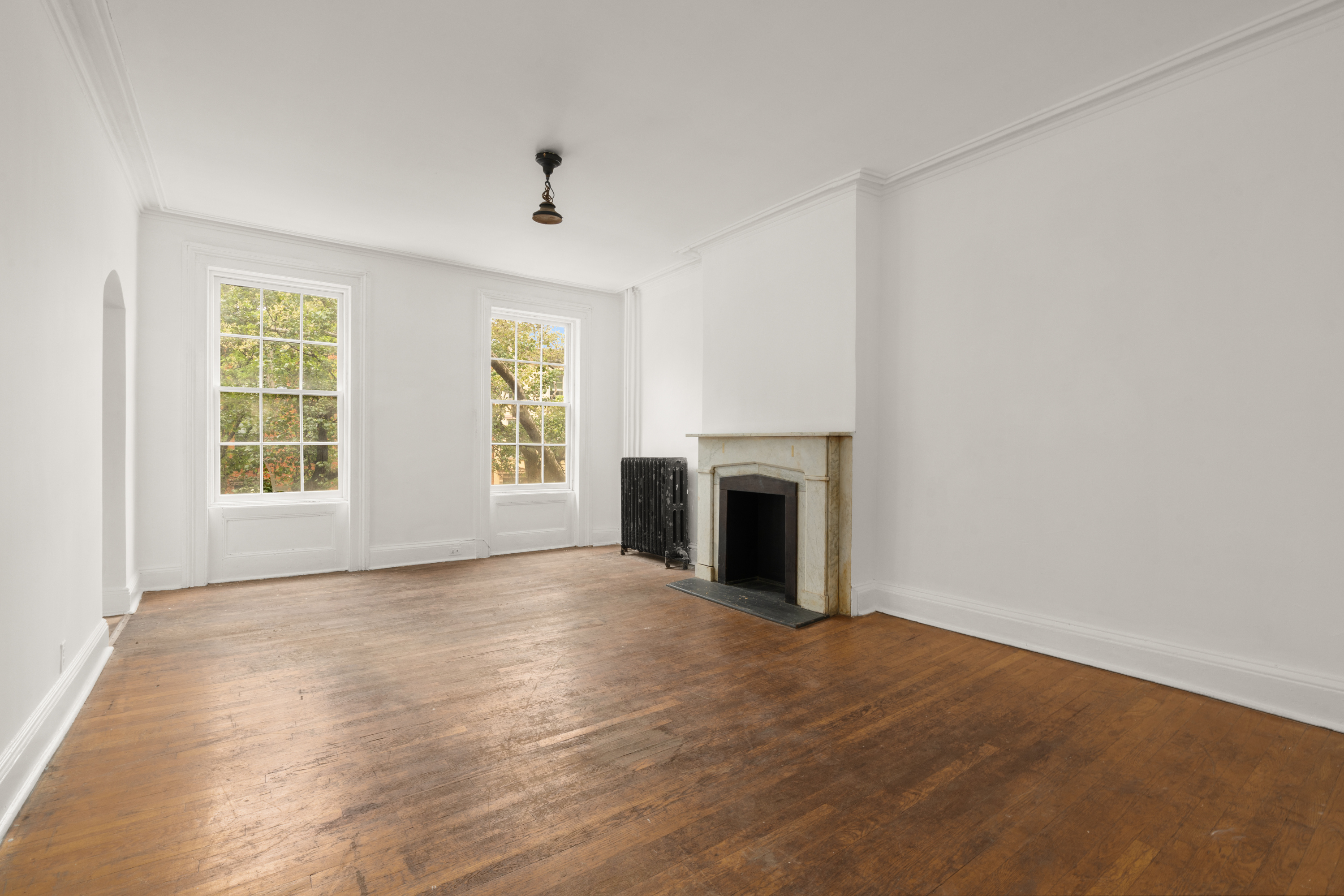 217 Dean Street Brooklyn, NY 11217 - Photo 9 of 26 an empty room with windows and fireplace
