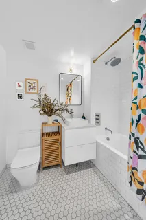 a bathroom with a sink a toilet and bathtub