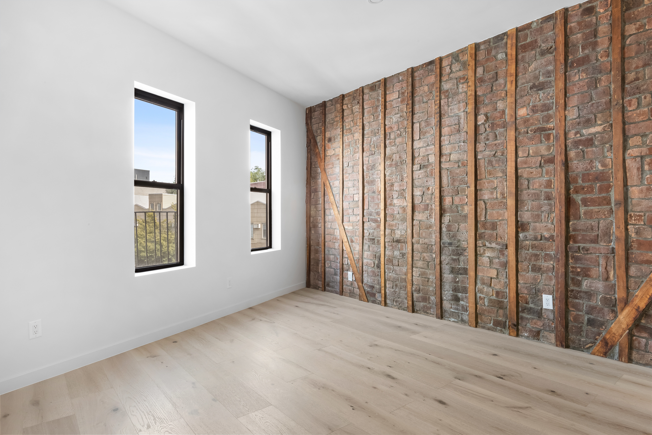 92 Jefferson Street, Unit 4 Brooklyn, NY 11206 - Photo 3 of 9 a view of an empty room with wooden floor and a window