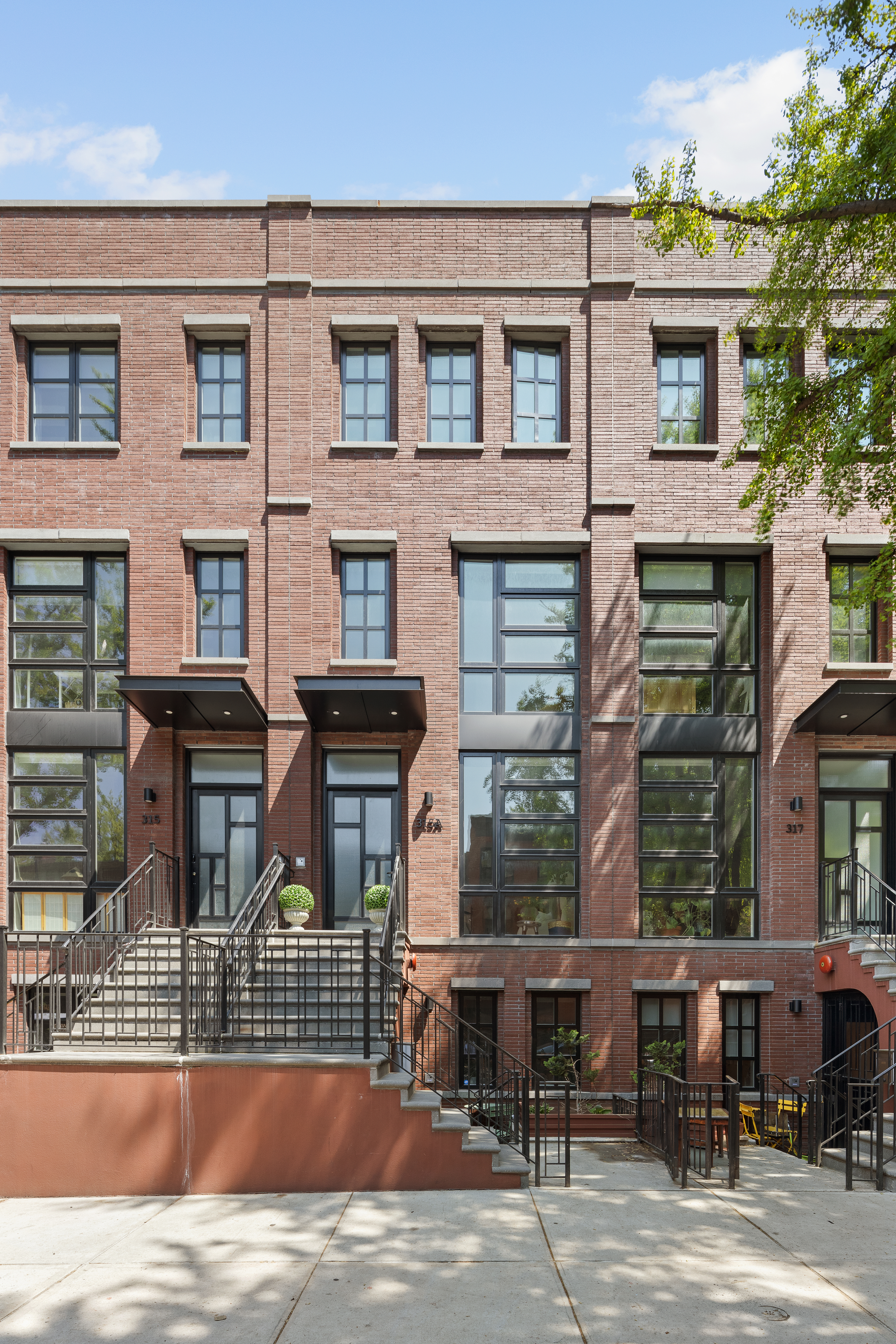 319 A State Street, Unit 2 Brooklyn, NY 11217 - Photo 14 of 15 a view of a brick building with a bench in front of building