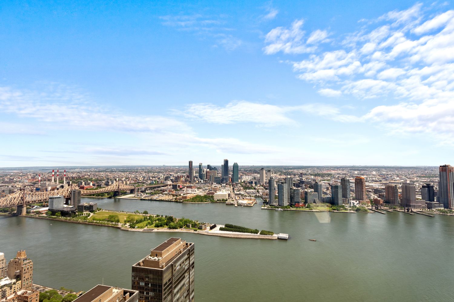 845 United Nations Plaza, Unit 63B Manhattan, NY 10017 - Photo 13 of 14 an aerial view of ocean and residential houses with outdoor space