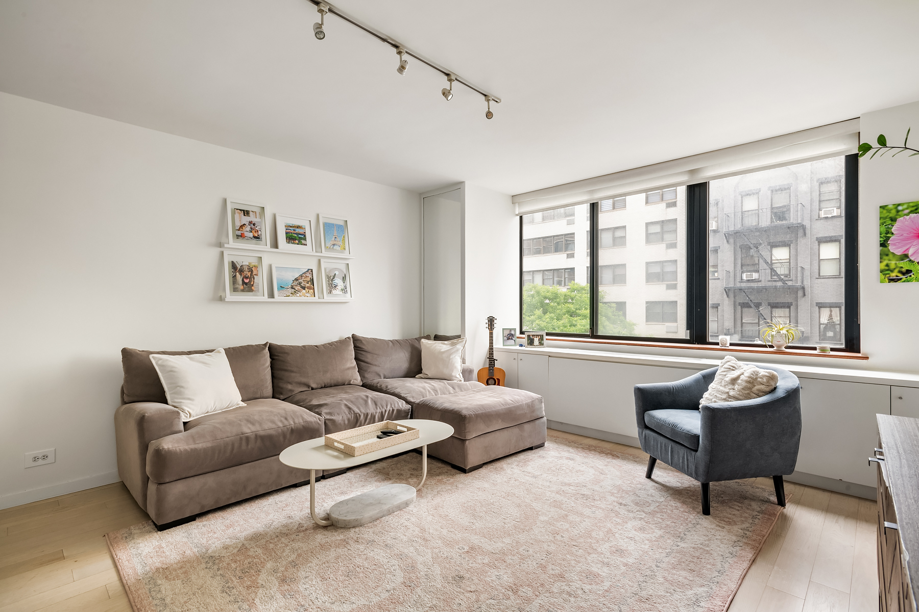 330 East 75th Street, Unit 3L Manhattan, NY 10021 - Photo 2 of 14 a living room with furniture and a large window