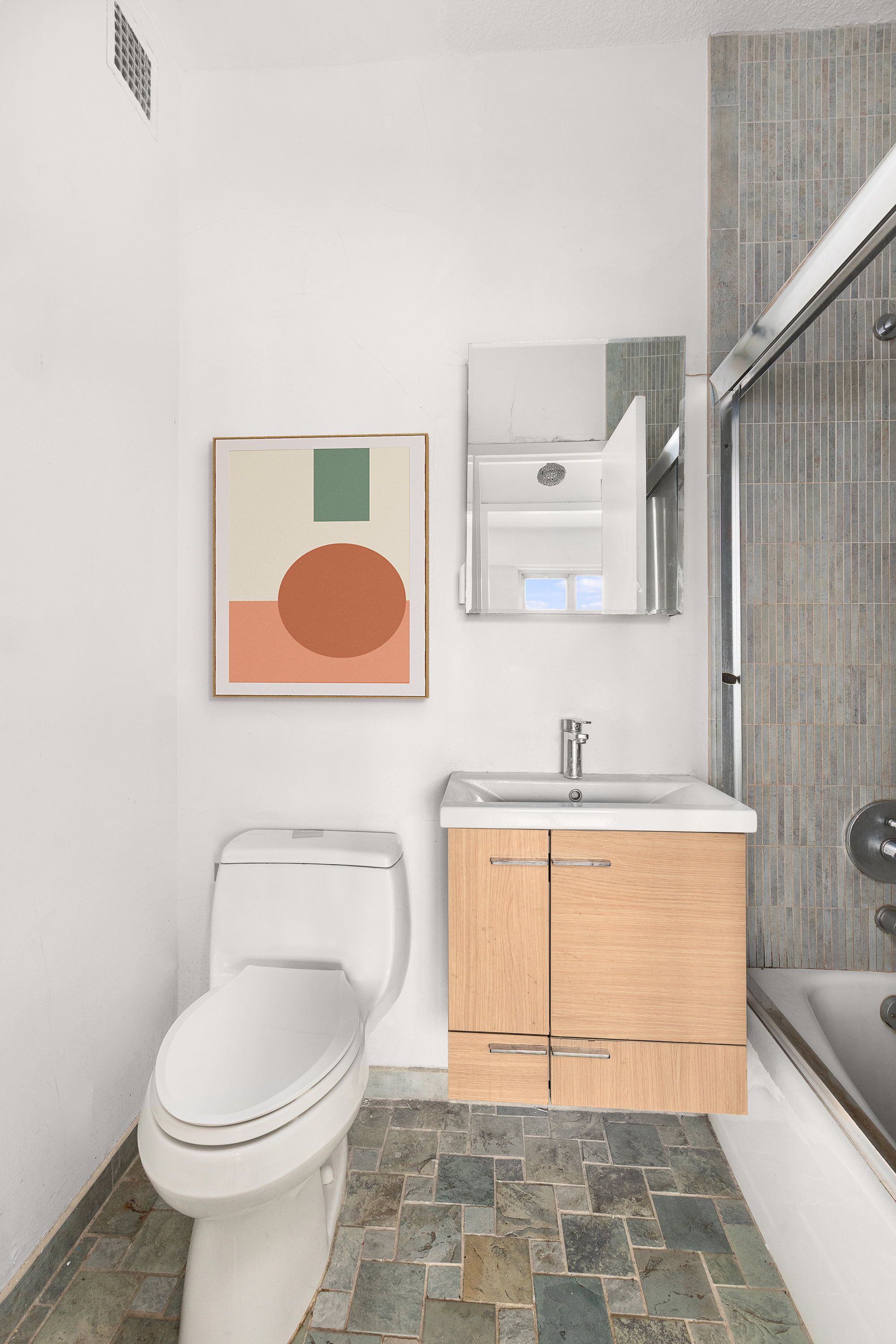 60 East 8th Street, Unit 18J Manhattan, NY 10003 - Photo 7 of 10 a bathroom with a sink a toilet and mirror