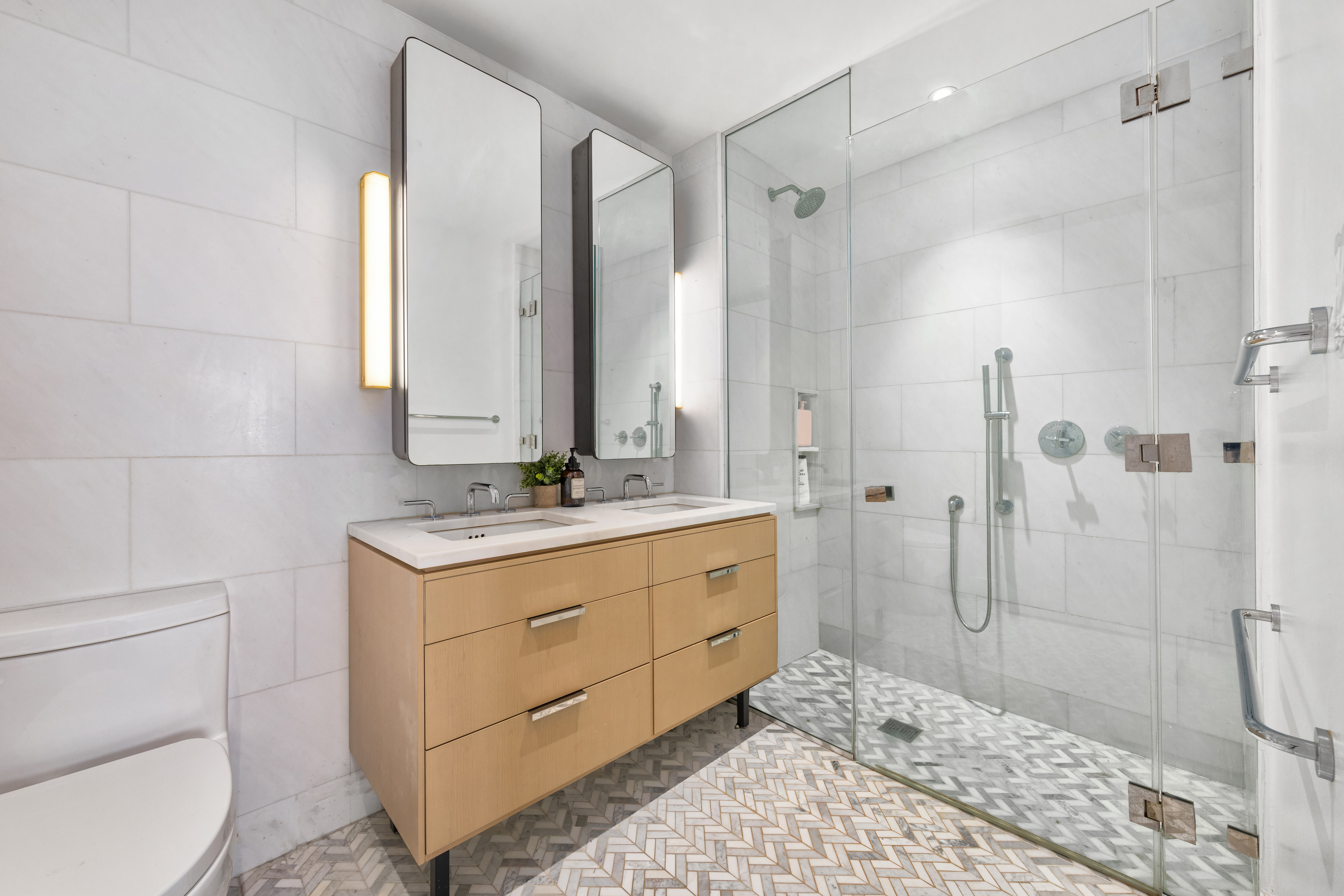 181 18th Street, Unit 204 Brooklyn, NY 11215 - Photo 4 of 15 a bathroom with a sink a toilet and shower