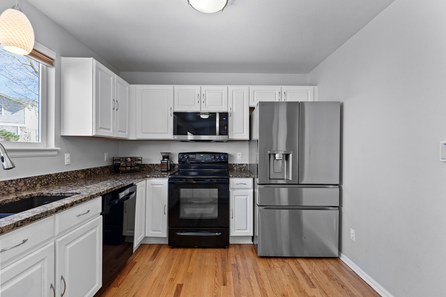 847 Timbervale Trail Highlands Ranch, CO 80129 - Photo 14 of 36 a kitchen with a refrigerator and a stove top oven