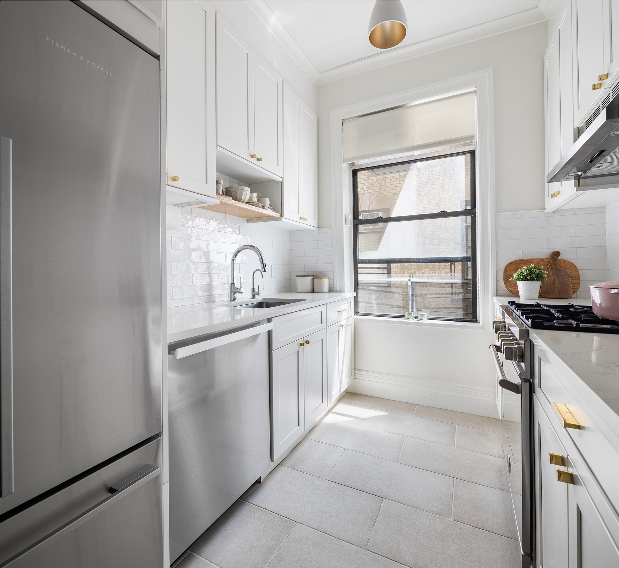 229 West 97th Street, Unit 5M New York, NY 10025 - Photo 5 of 11 a kitchen with a sink stove and cabinets