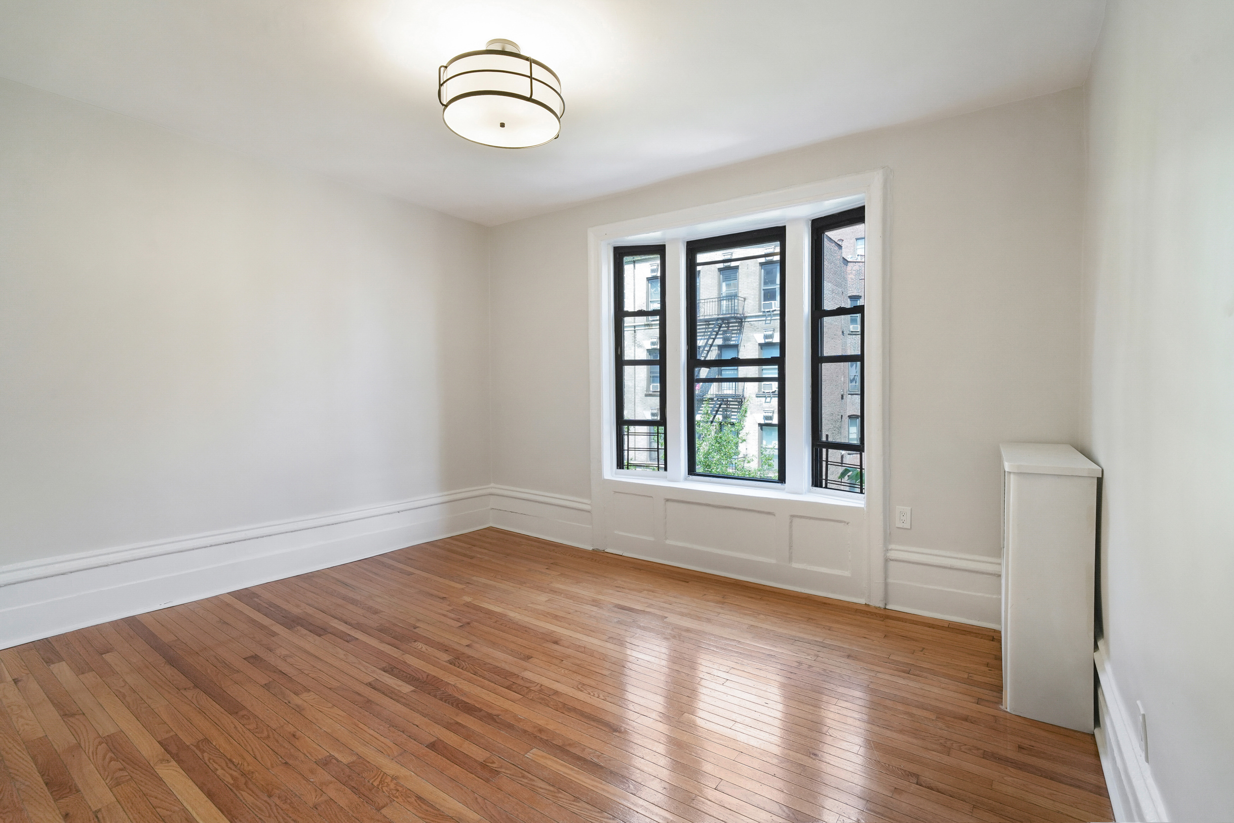 200 West 109th Street, Unit C1 Manhattan, NY 10025 - Photo 9 of 16 wooden floor in a room next to a window