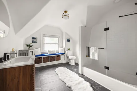 a living room with a bed furniture and a window