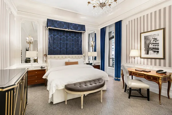 a bed room with a bed and a chair