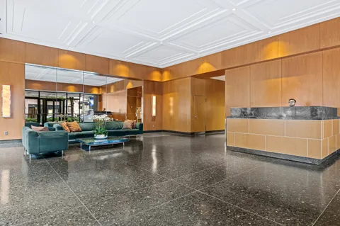 a living room with a table and a potted plant