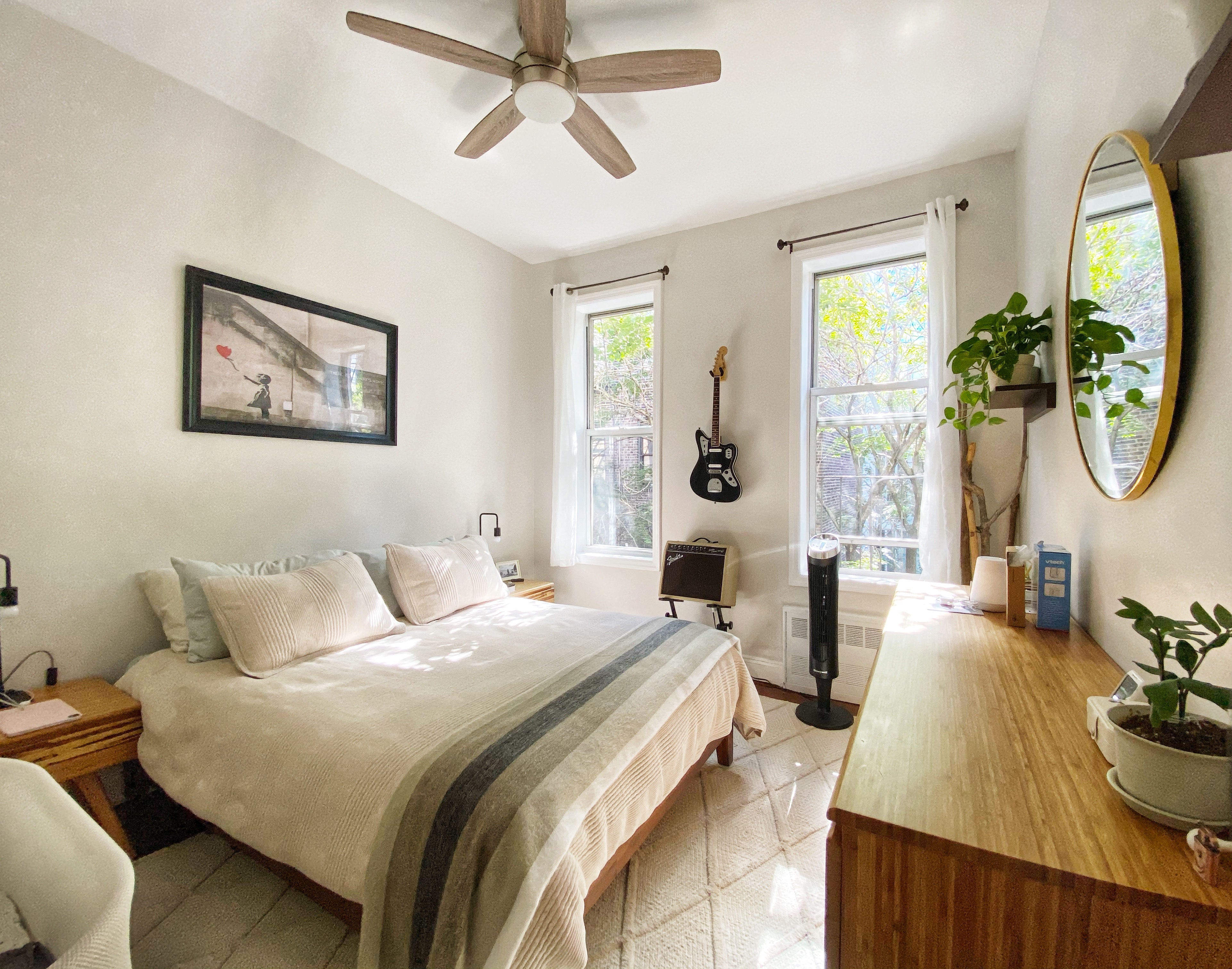 406 West 46th Street, Unit 4C Manhattan, NY 10036 - Photo 4 of 9 a bedroom with a bed a mirror and a large window