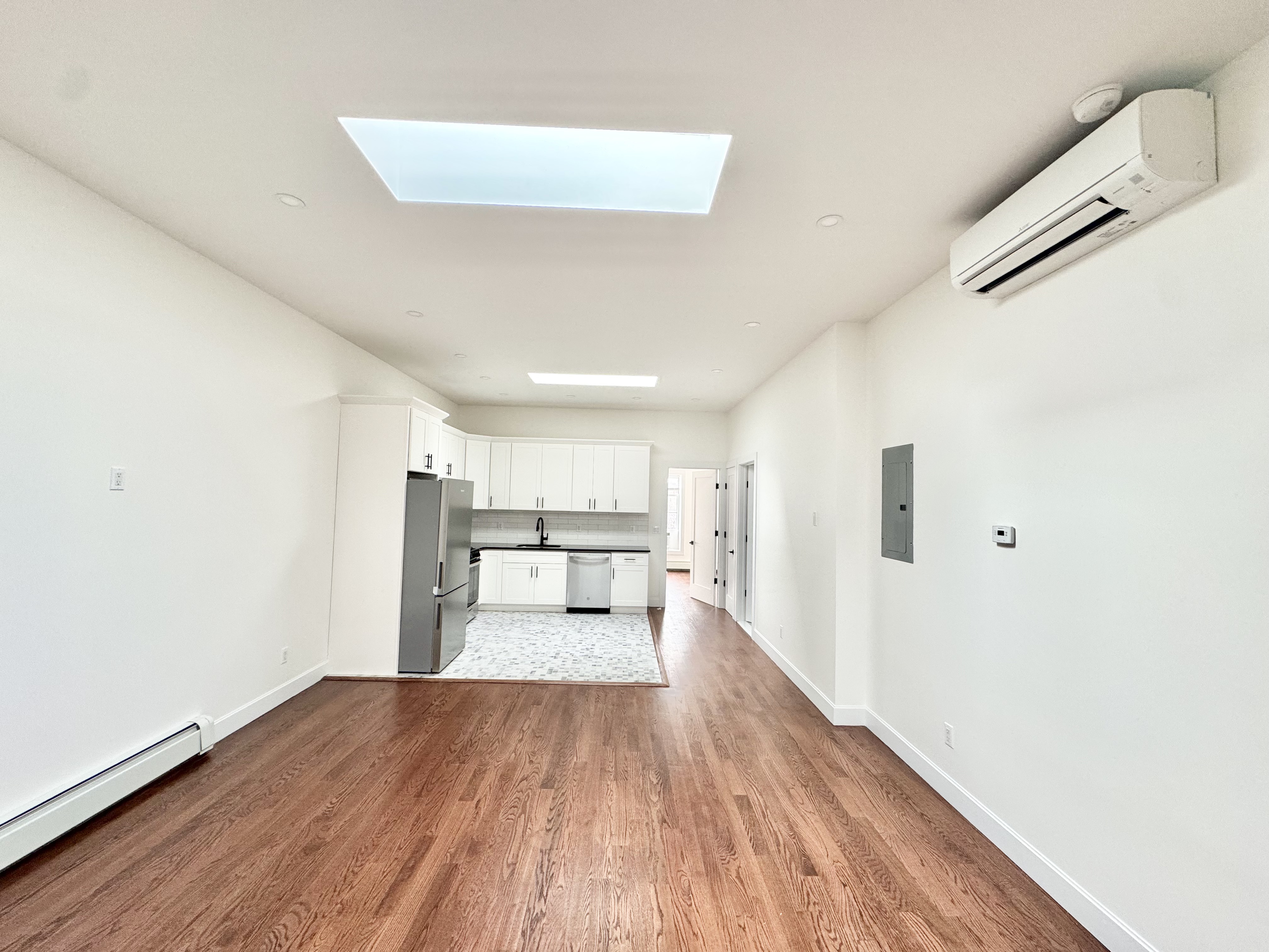 383 Myrtle Avenue, Unit 3 Brooklyn, NY 11205 - Photo 11 of 21 a view of a kitchen with wooden floor and electronic appliances