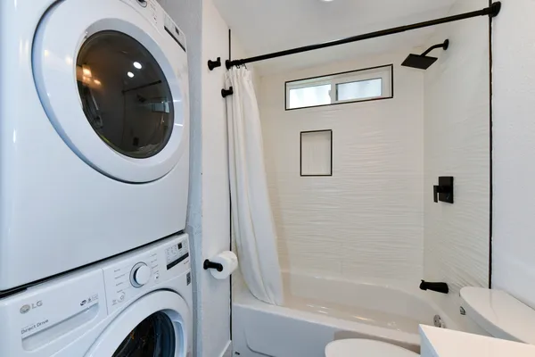 a bathroom with a sink a toilet and a shower