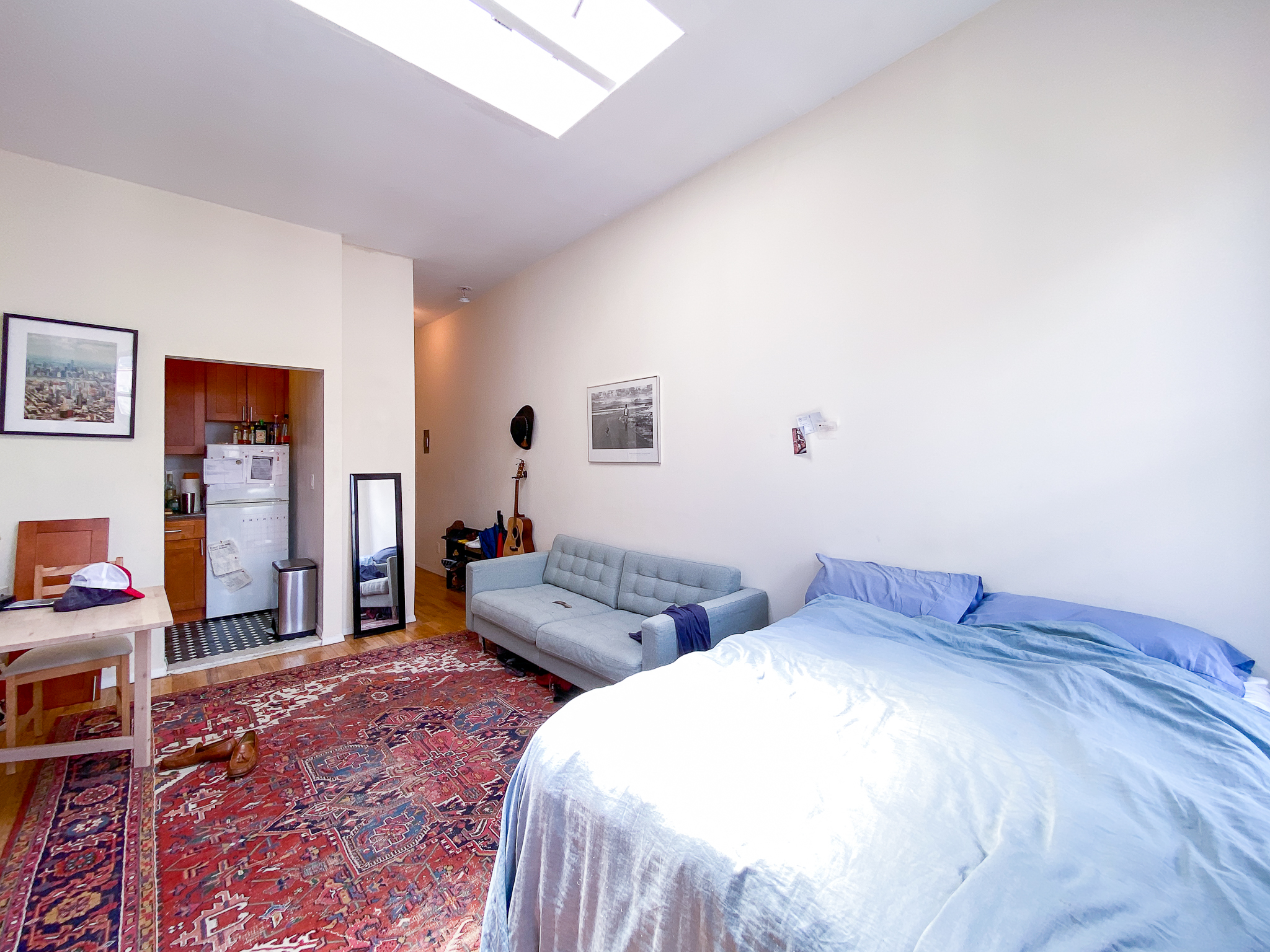 238 West 20th Street, Unit 5B Manhattan, NY 10011 - Photo 2 of 12 a bedroom with two beds and a bookshelf