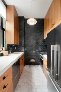 a large kitchen with stainless steel appliances granite countertop a sink stove and refrigerator