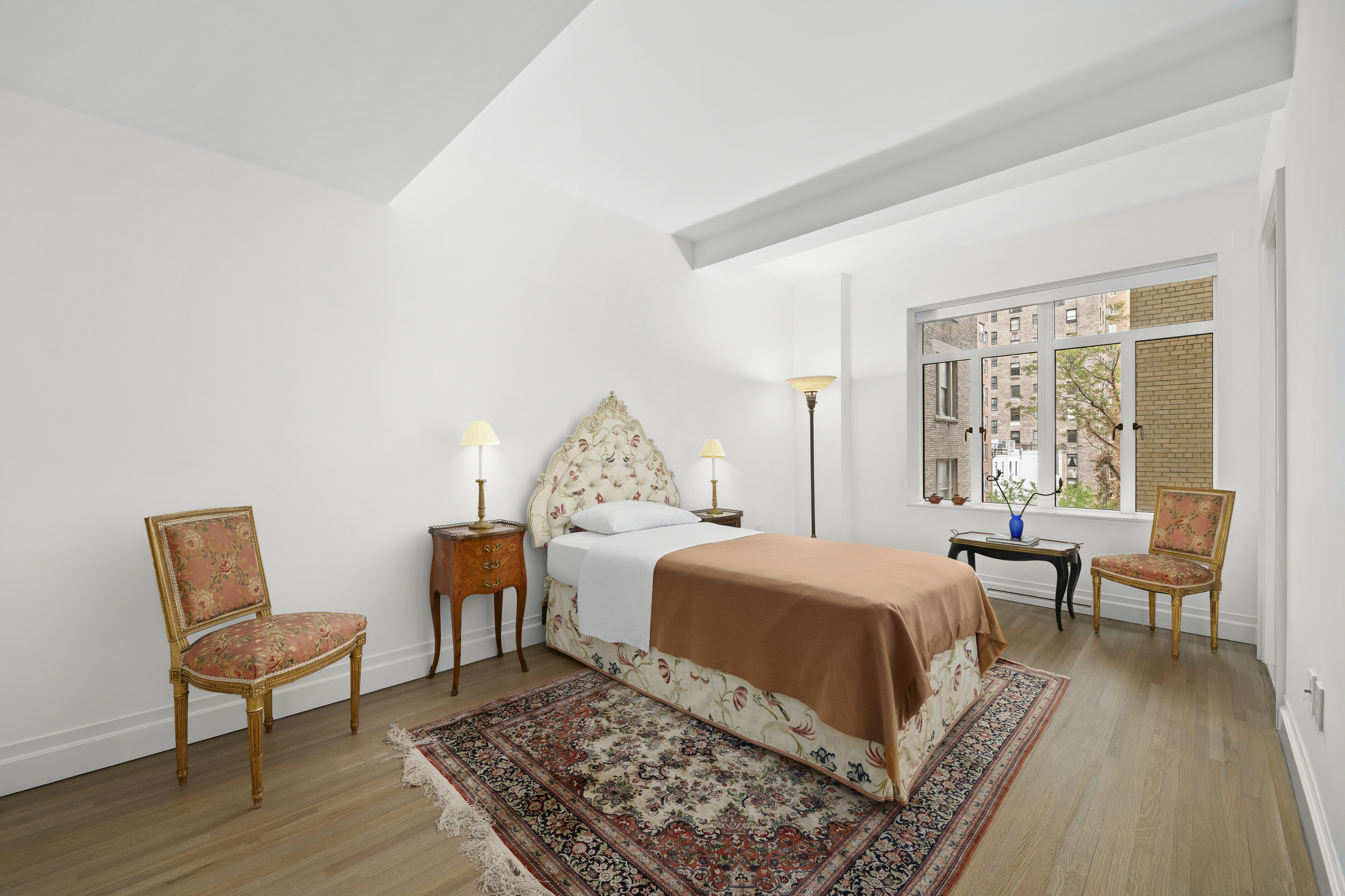 737 Park Avenue, Unit 6A Manhattan, NY 10021 - Photo 6 of 14 a bedroom with a bed and wooden floor