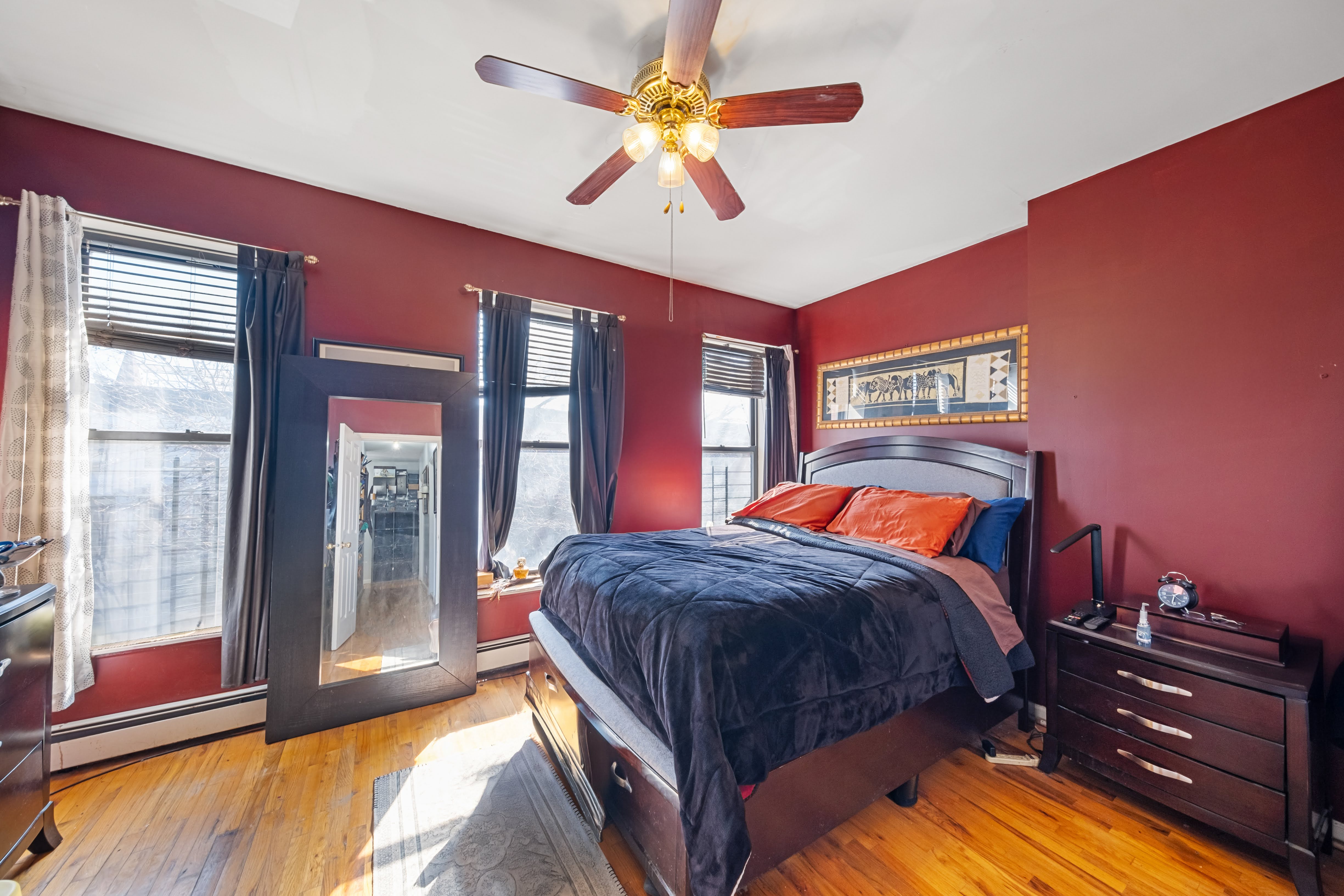275 Van Buren Street Brooklyn, NY 11221 - Photo 12 of 33 a bedroom with a bed and a chandelier