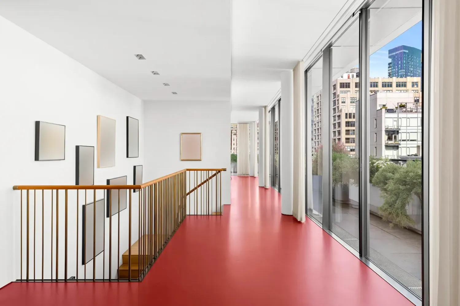 a view of a hallway with wooden floor and windows