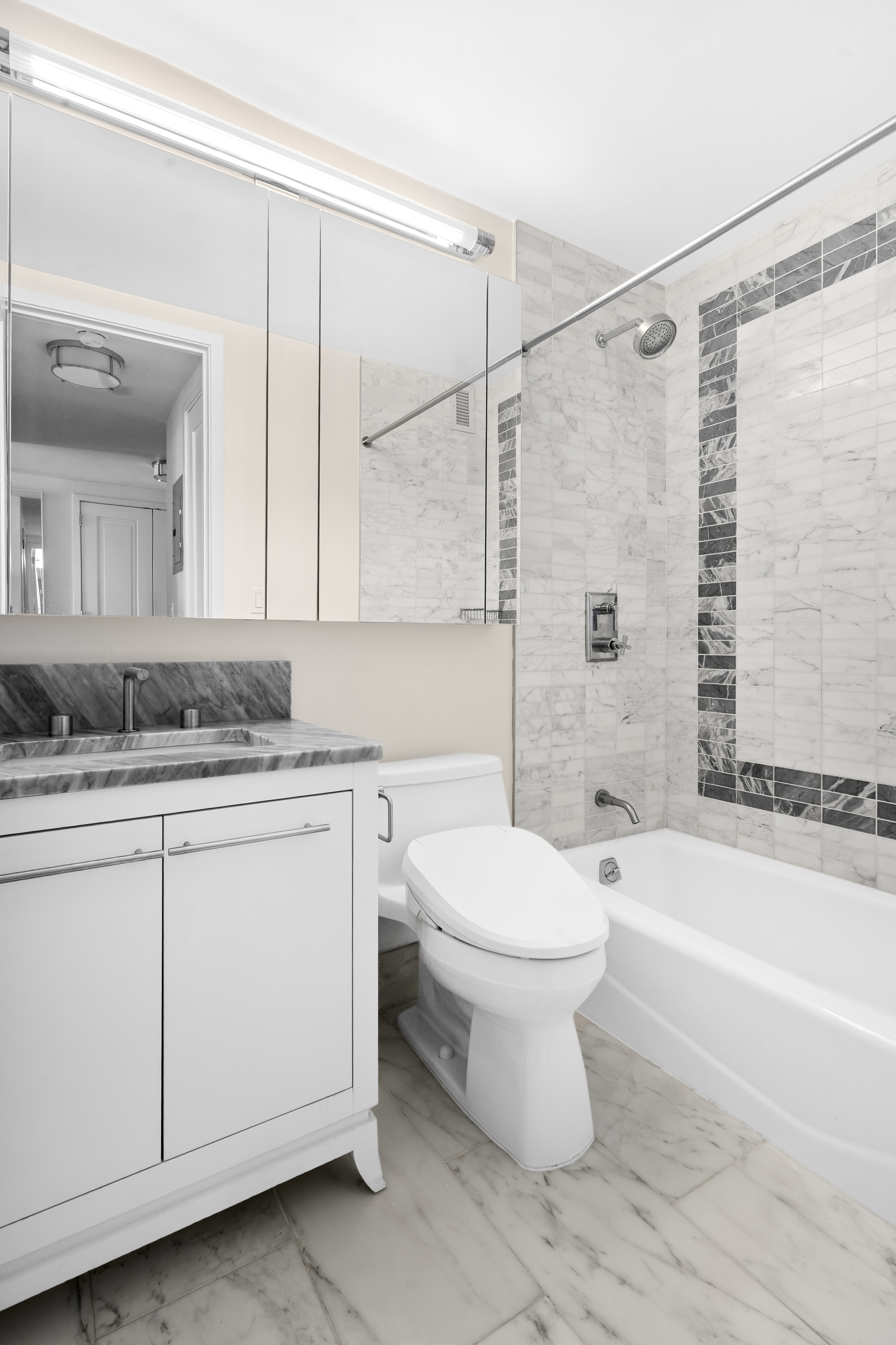 200 East 94th Street, Unit 2911 Manhattan, NY 10128 - Photo 7 of 20 a bathroom with a sink toilet and shower