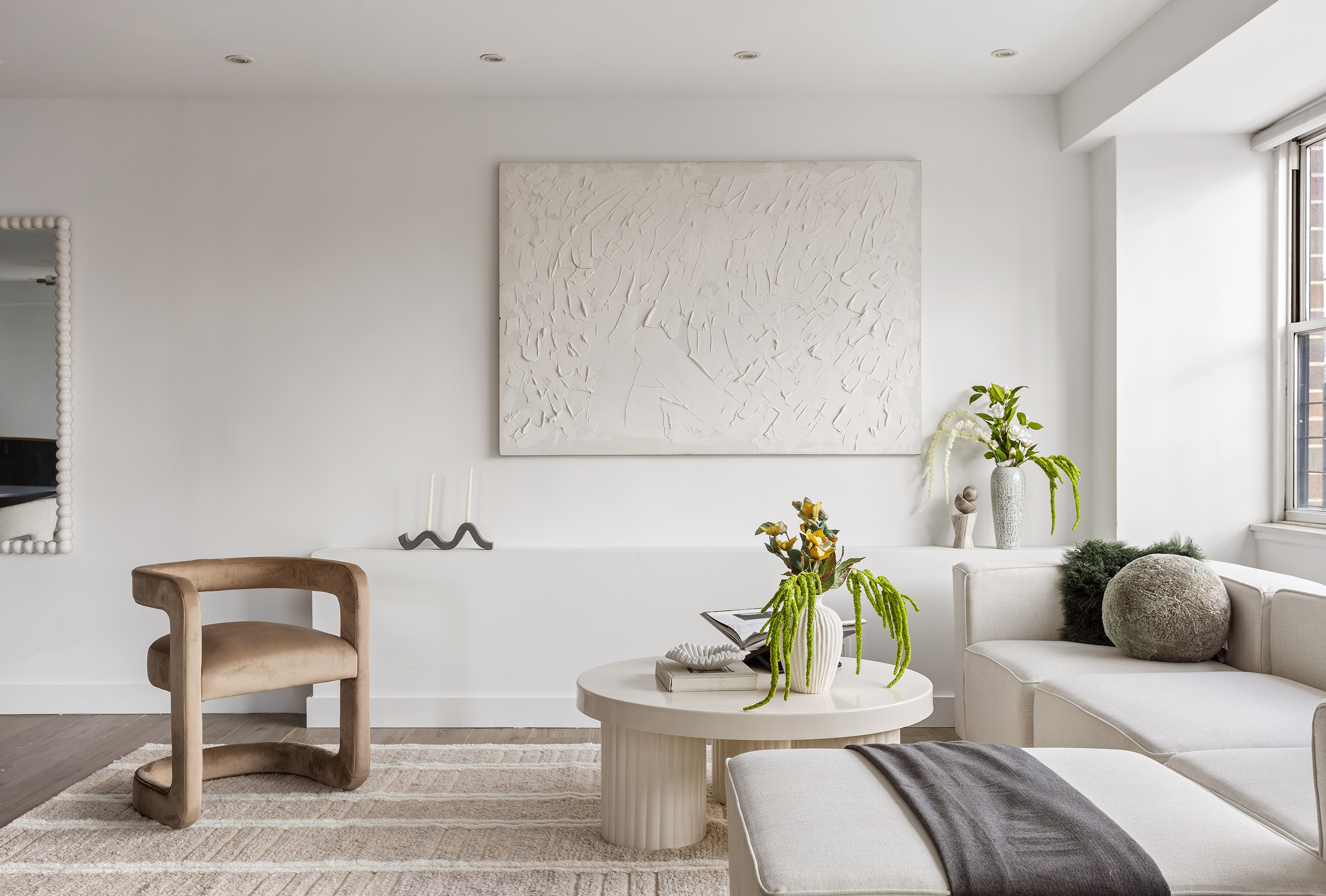340 East 64th Street, Unit 19L Manhattan, NY 10065 - Photo 3 of 17 a living room with furniture and a potted plant