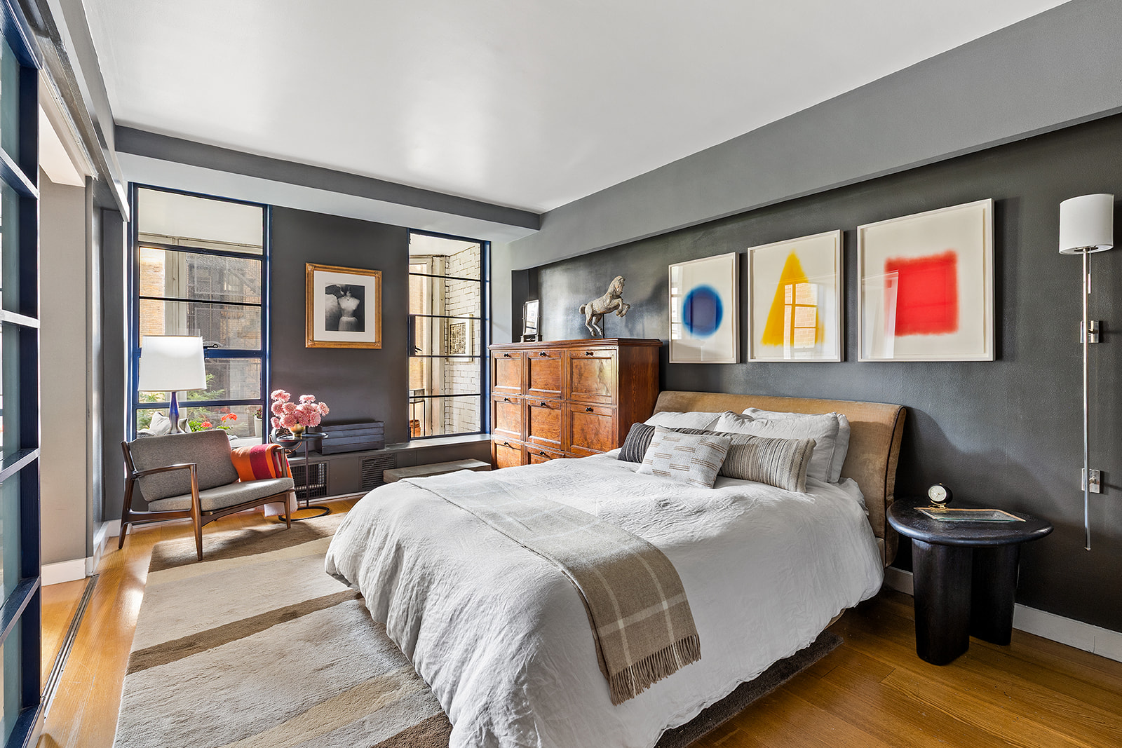 37 West 12th Street, Unit 6G Manhattan, NY 10011 - Photo 12 of 17 a bedroom with a bed and wooden floor