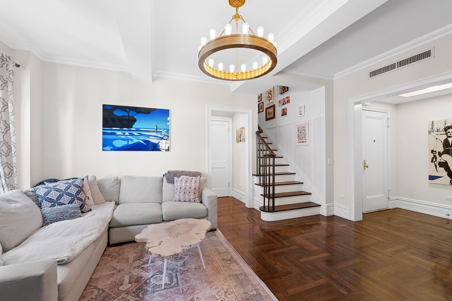 a living room with furniture and a painting