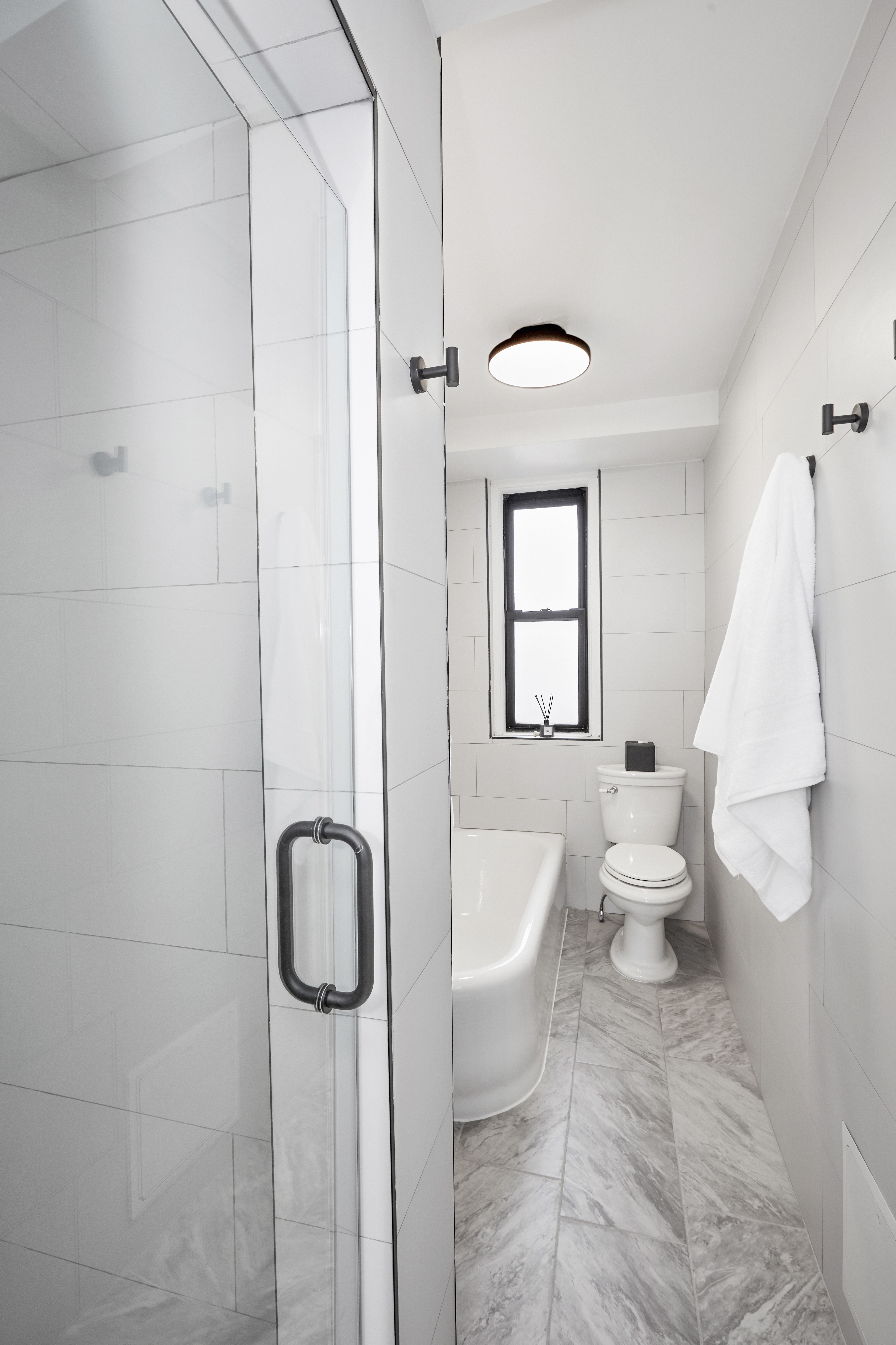 135 Eastern Parkway, Unit 9I Brooklyn, NY 11238 - Photo 4 of 17 a bathroom with a toilet sink and shower