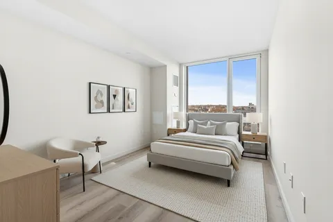 a bed room with a bed and a window