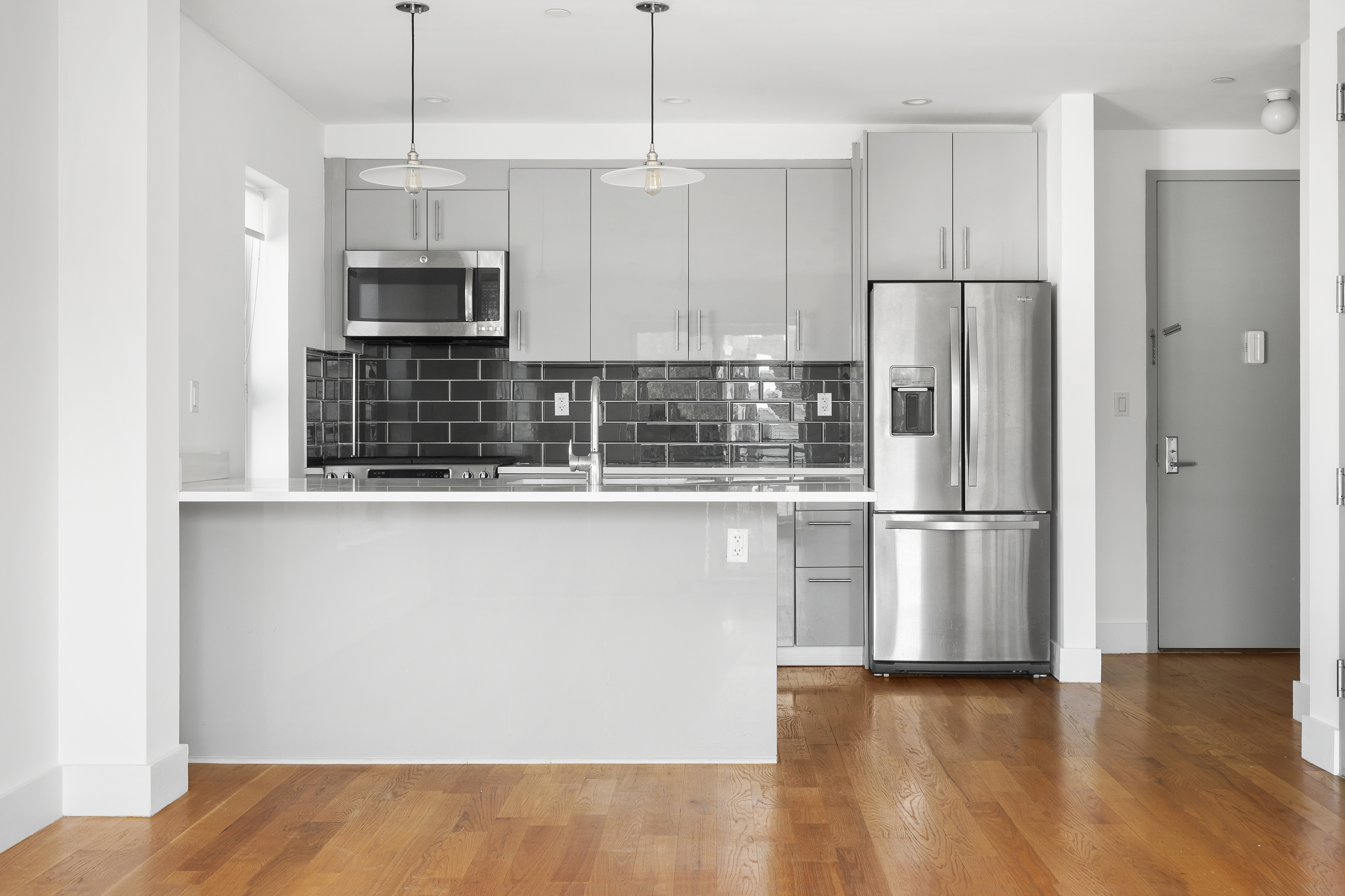 63-34 Fresh Pond Road, Unit 3D Queens, NY 11385 - Photo 2 of 14 a kitchen with stainless steel appliances granite countertop a refrigerator a sink and a stove