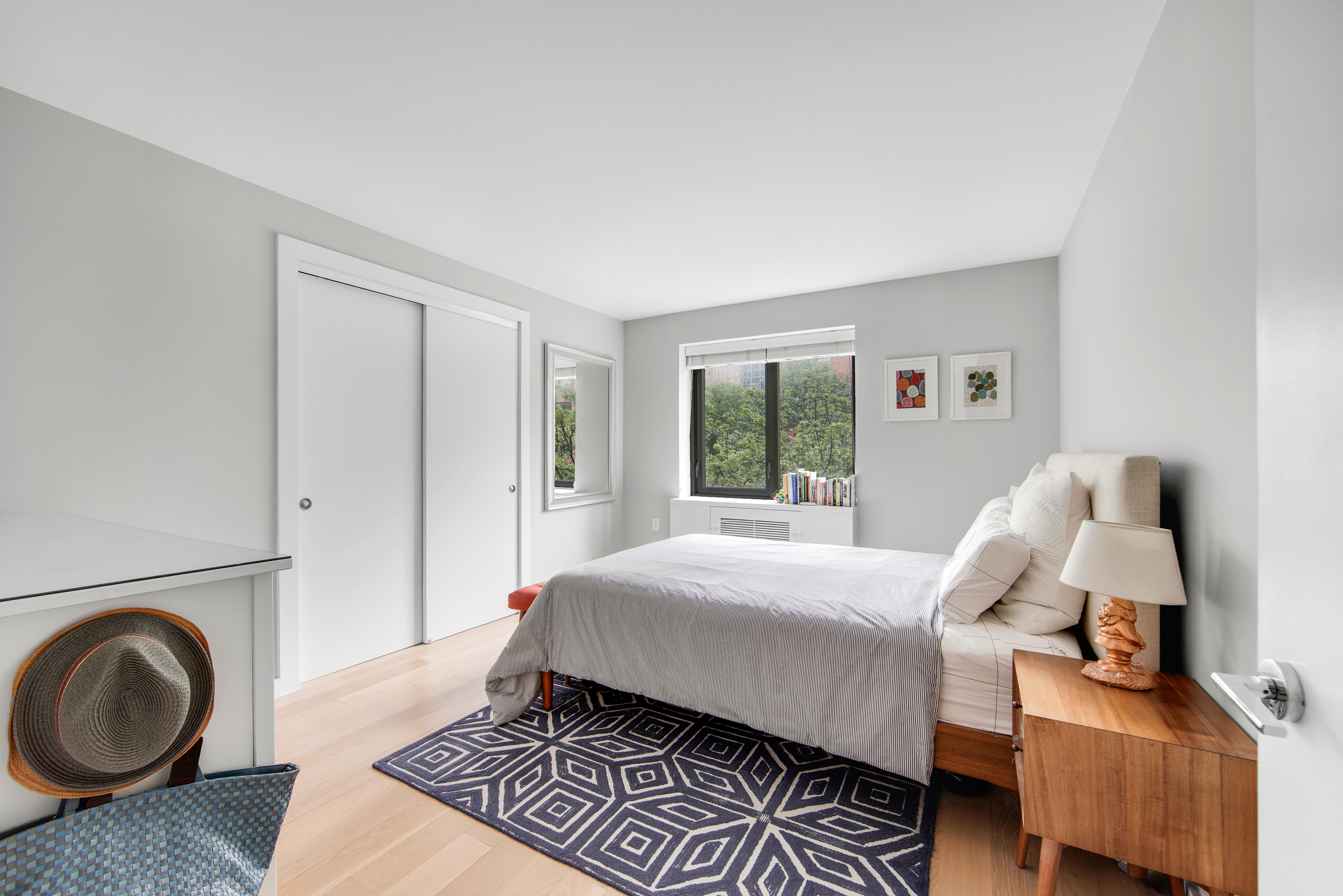 1330 5th Avenue, Unit 3F Manhattan, NY 10026 - Photo 6 of 16 a bedroom with a bed and wooden floor